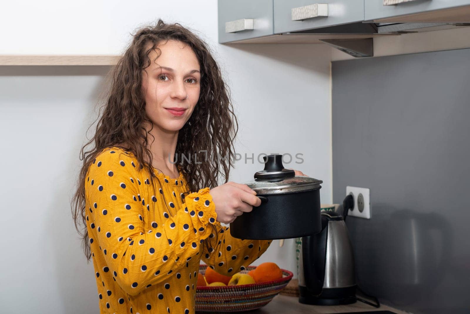 a young woman with long hair is in the kitchen