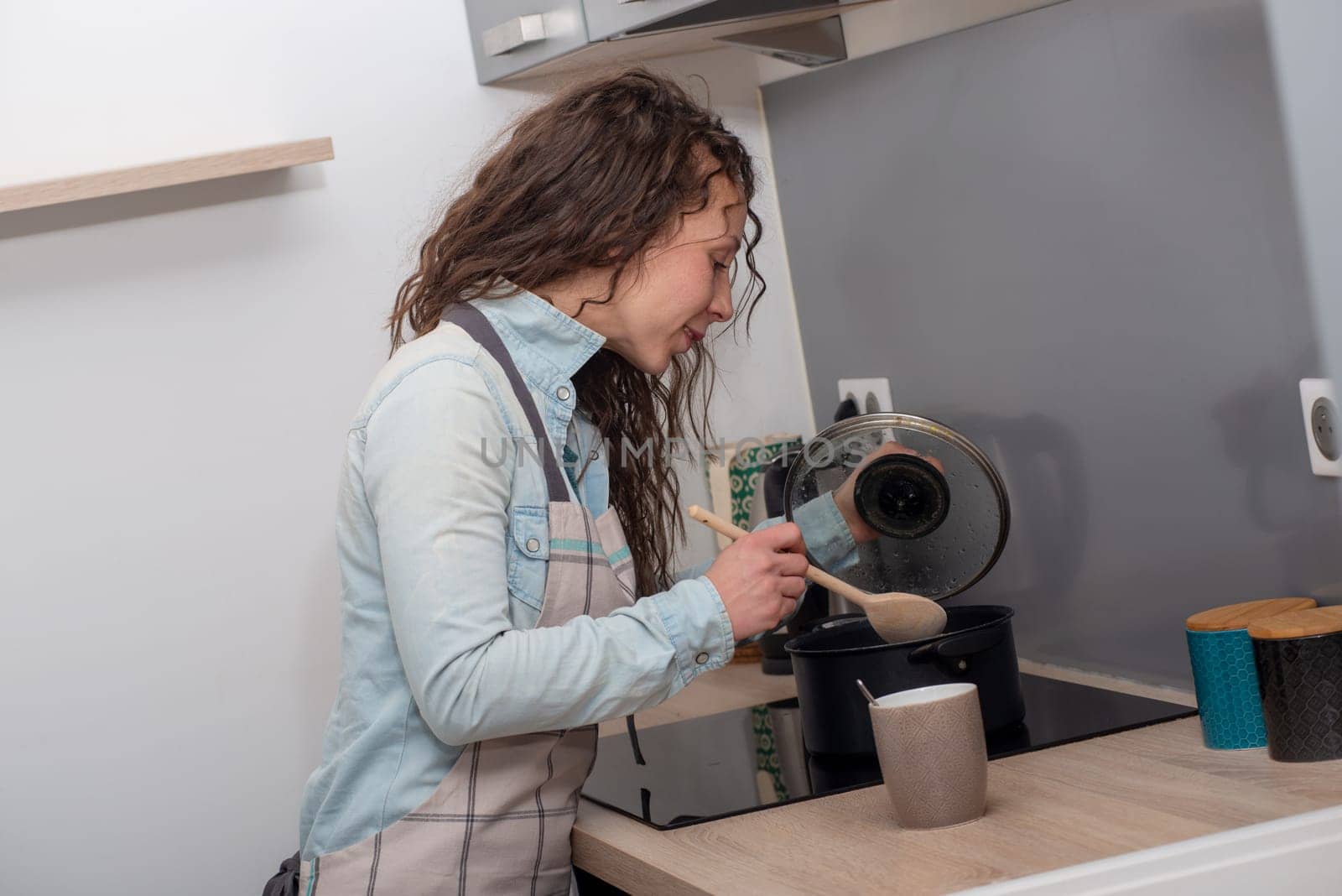 a young woman with long hair is in the kitchen