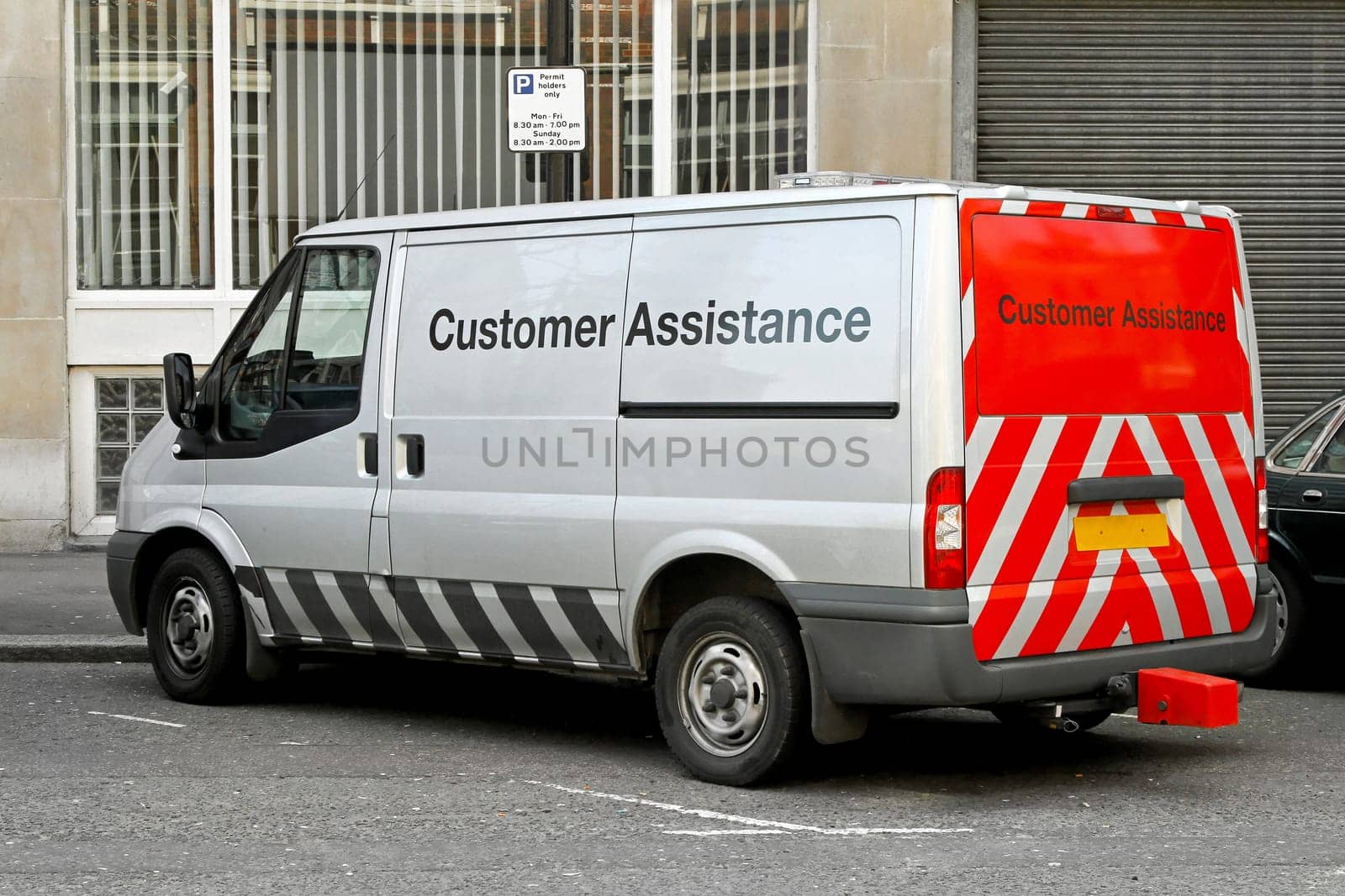 Commercial van for customer assistance parked on a street