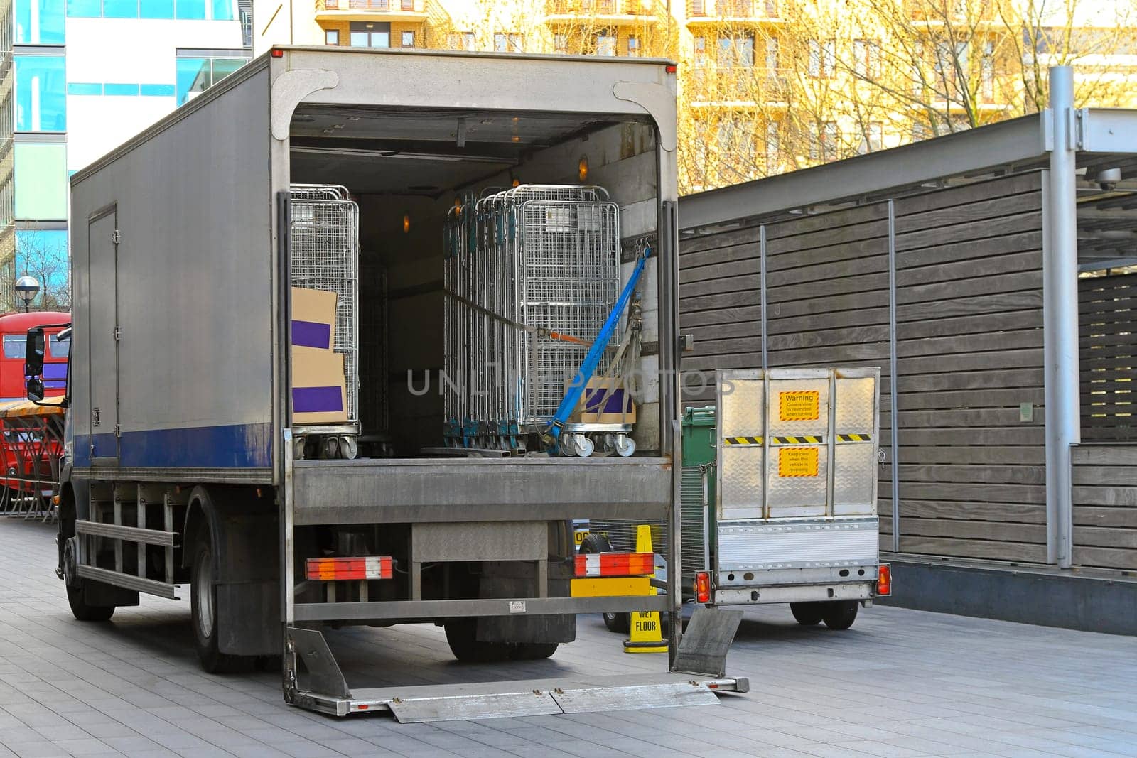 Open back door of delivery truck parked outside store