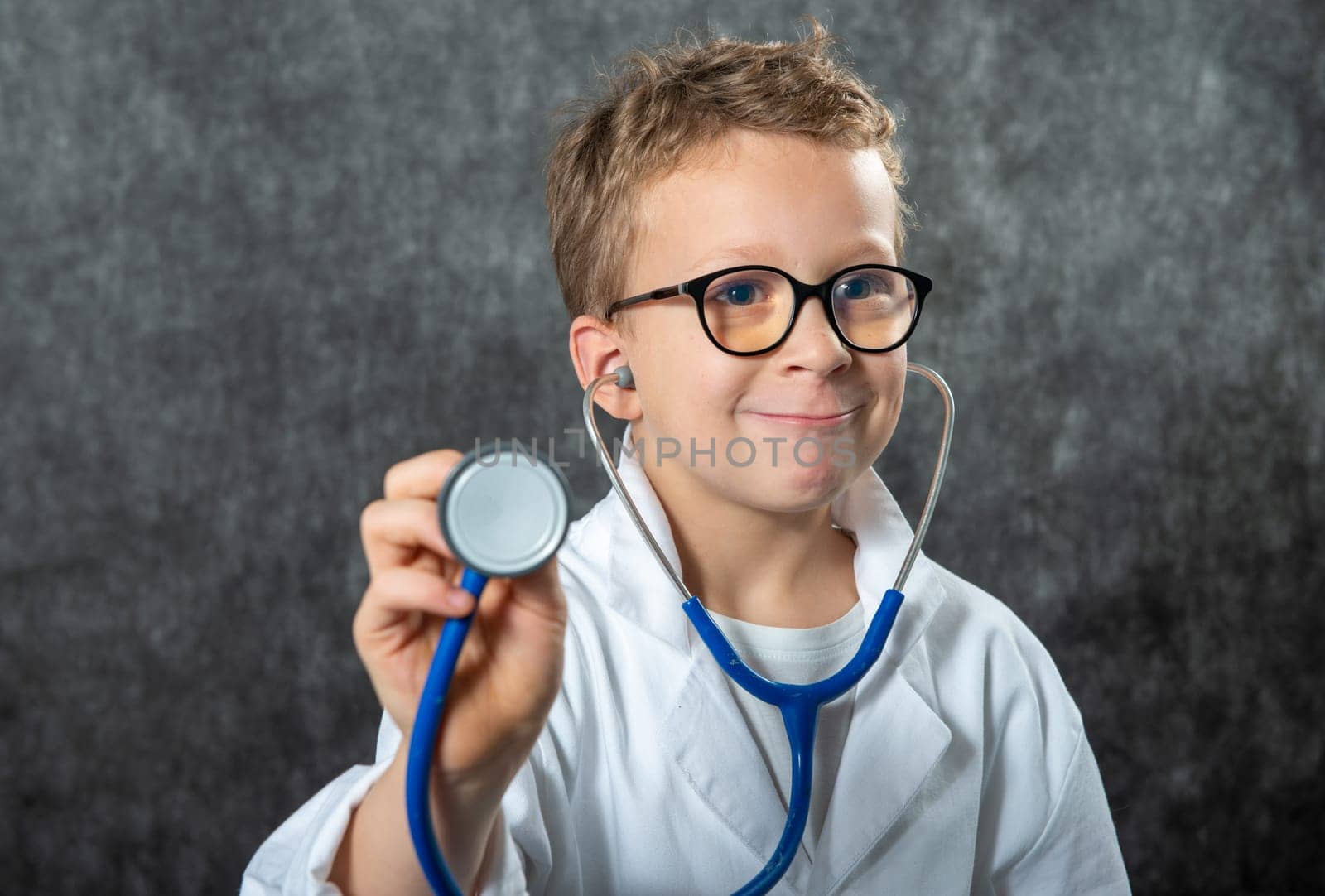 Cute kid boy wear medical uniform playing doctor, a portrait