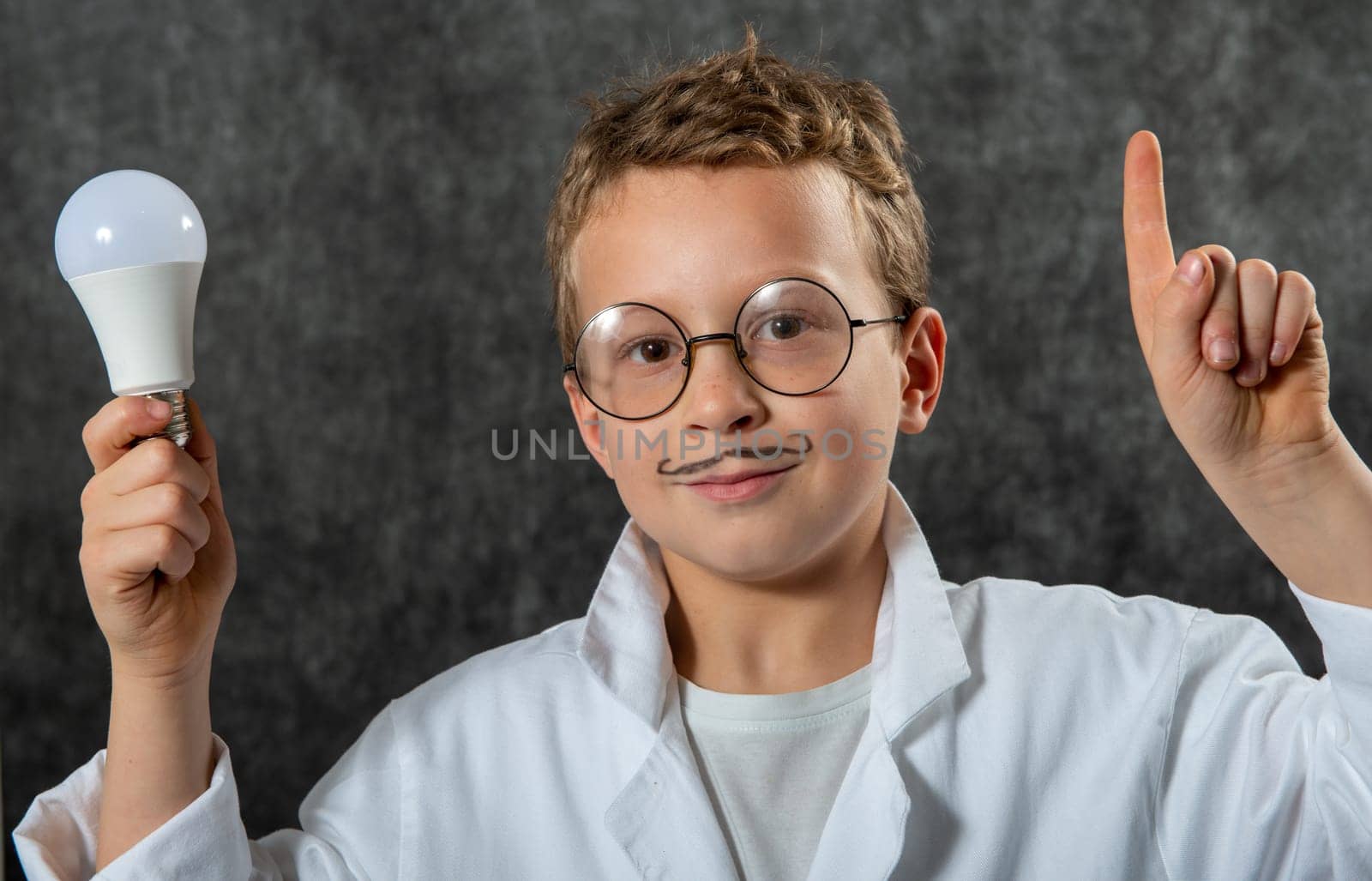 cute smiling child boy with a light bulb