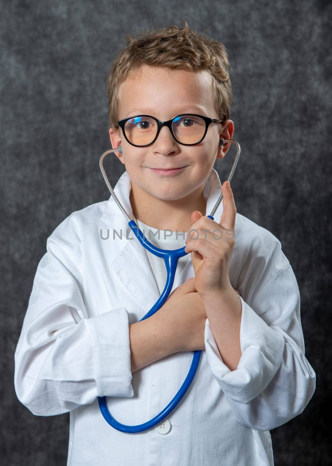 Cute kid boy wear medical uniform playing doctor, a portrait