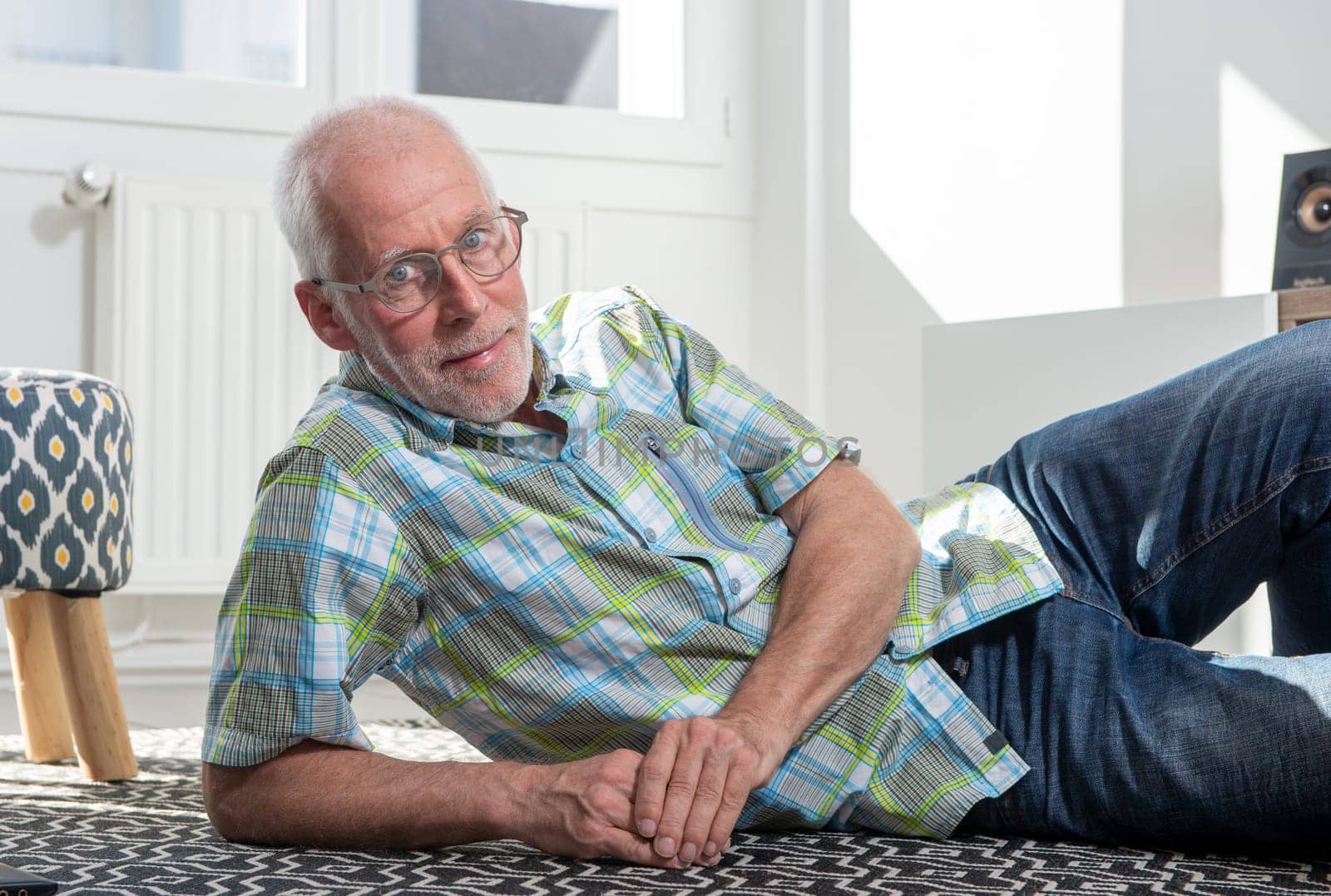 a senior man lying on floor and resting