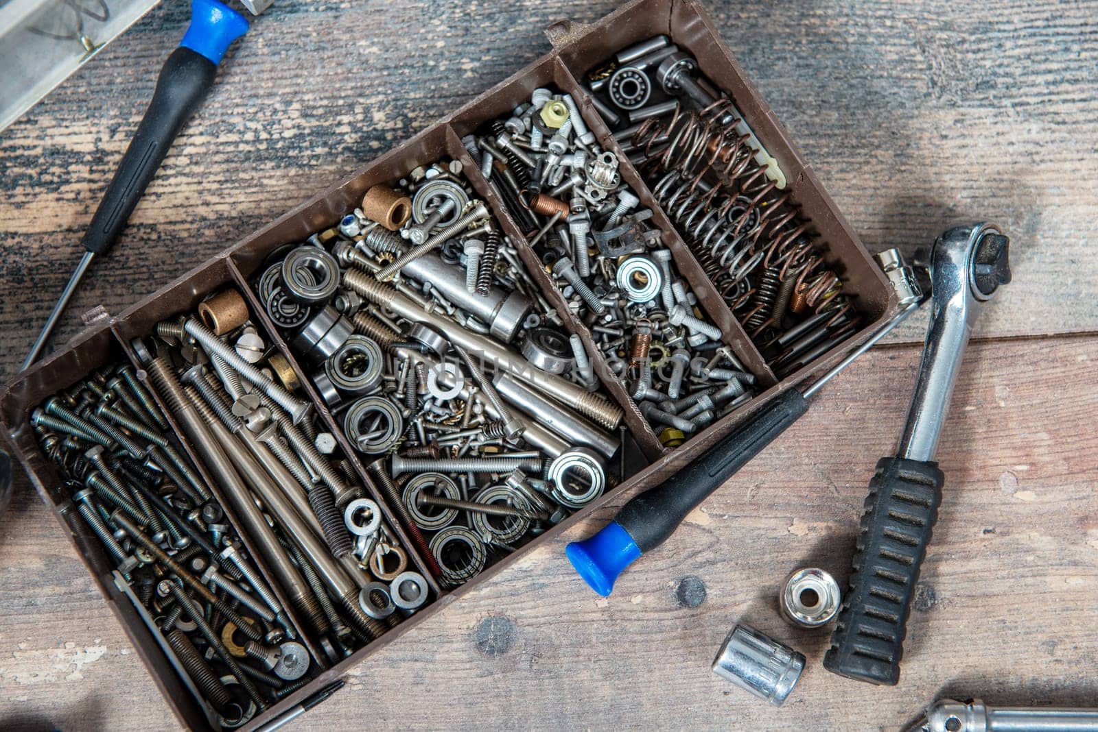 a plastic toolbox with small screws