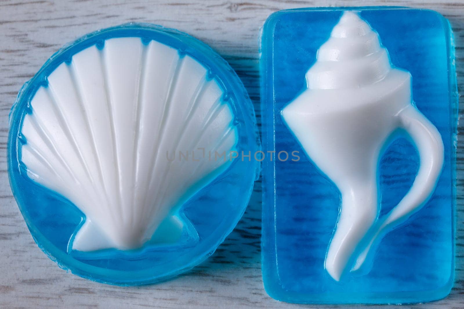 Glycerin base soap handmade with a white shell on a blue transparent base lying on the table