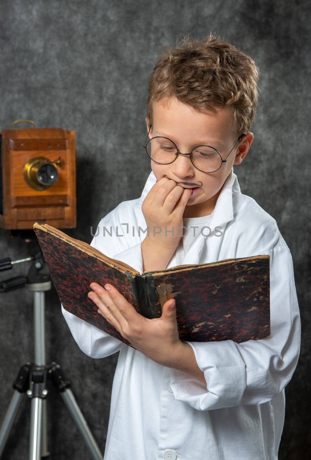 cheerful boy retro with a white blouse reading a book