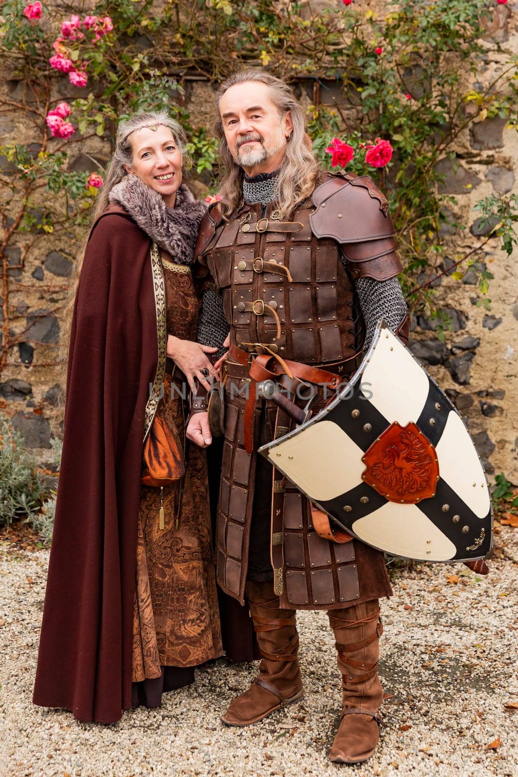Couple posing robed in beautiful medieval clothing