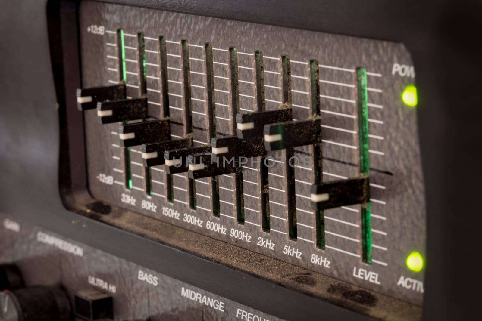 Old black dusty controls of an audio equalizer from a guitar amplifier