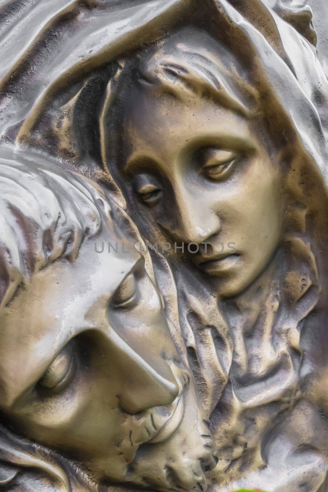 Bronze Statue of dead Jesus Christ down from the cross, being embraced by the Virgin Mary. It can be used for concepts and events.