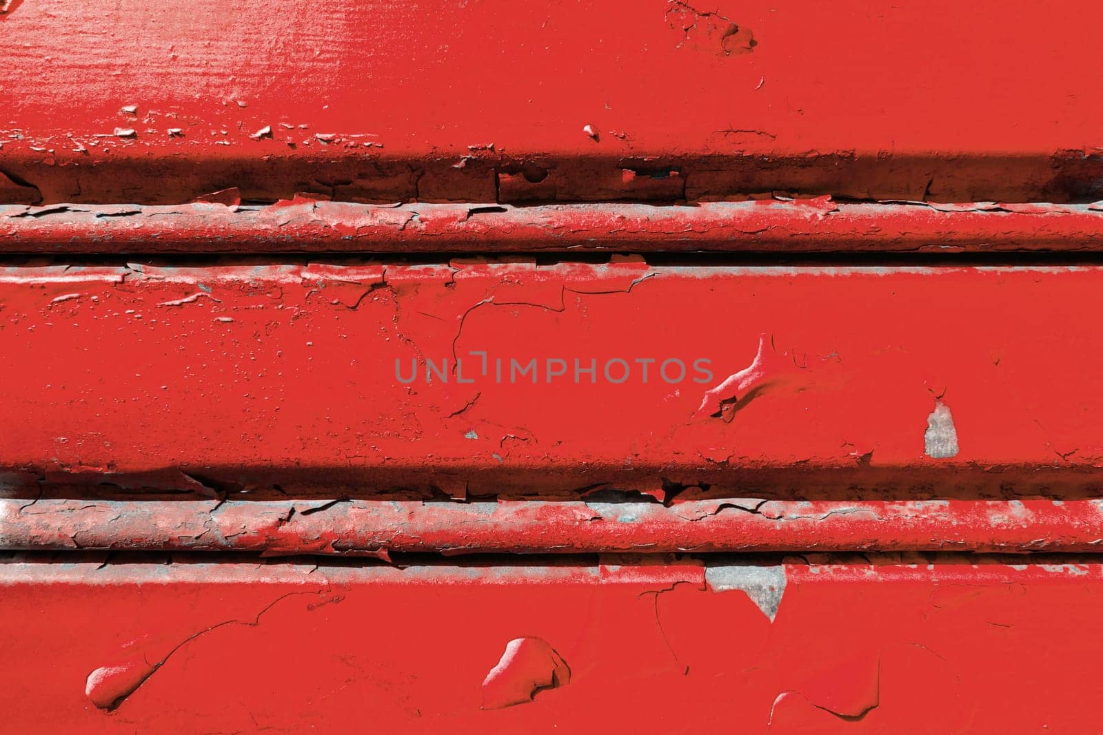 Background of old metal sheet with peel paint texture surface. Painted metal roller shutters door with peeling paint dirty red hue. Grungy background texture.