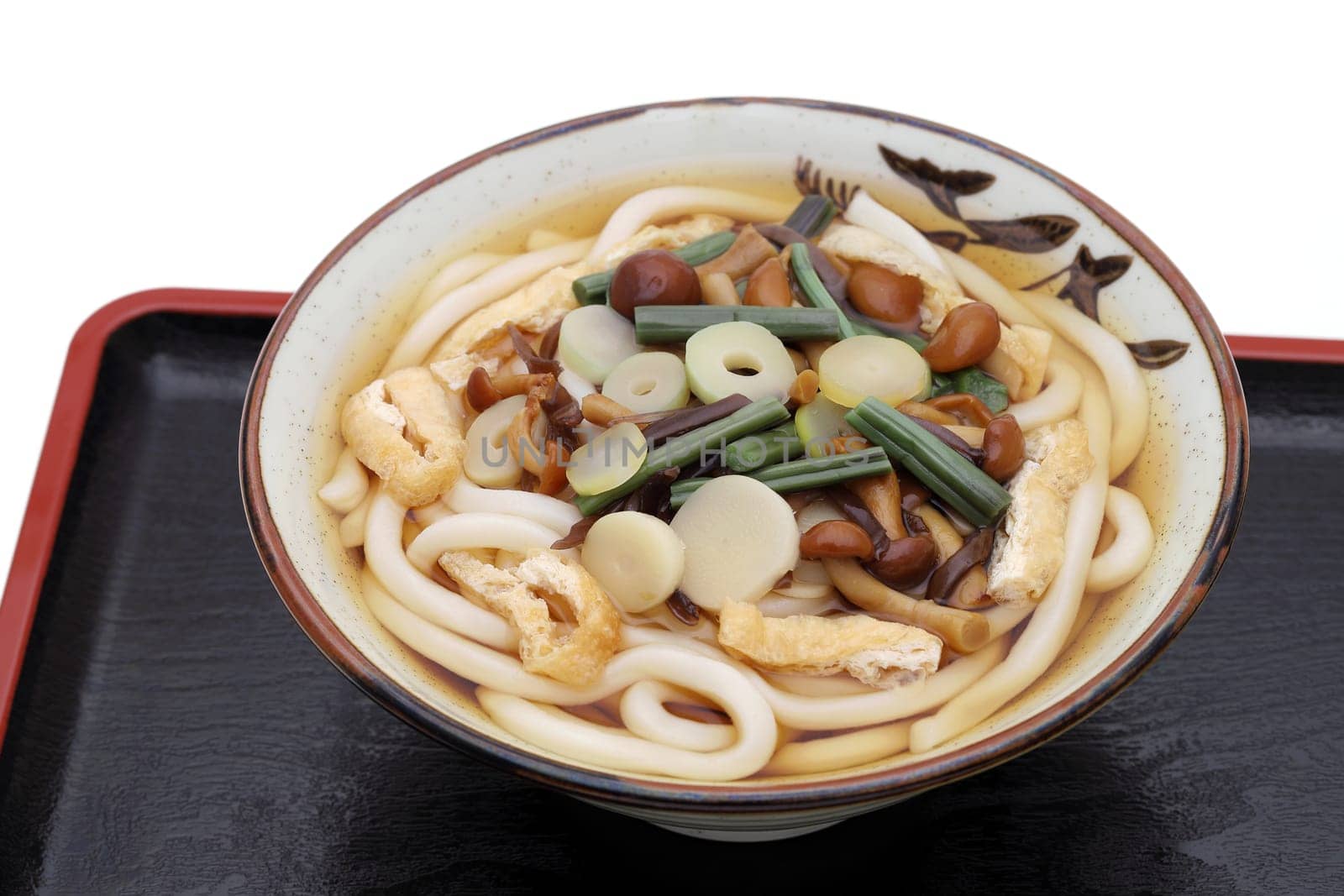 Japanese udon noodles in a ceramic bowl on tray