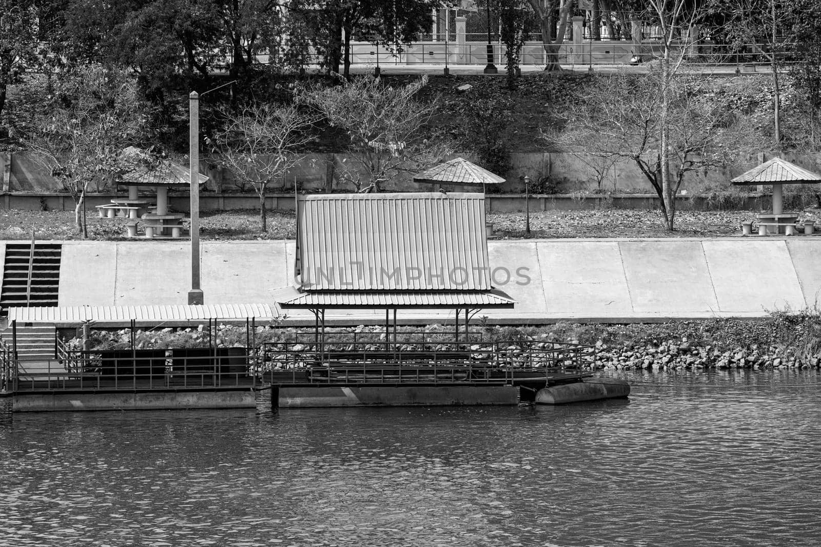 floating platform roof metallic structure leisure activity river black white