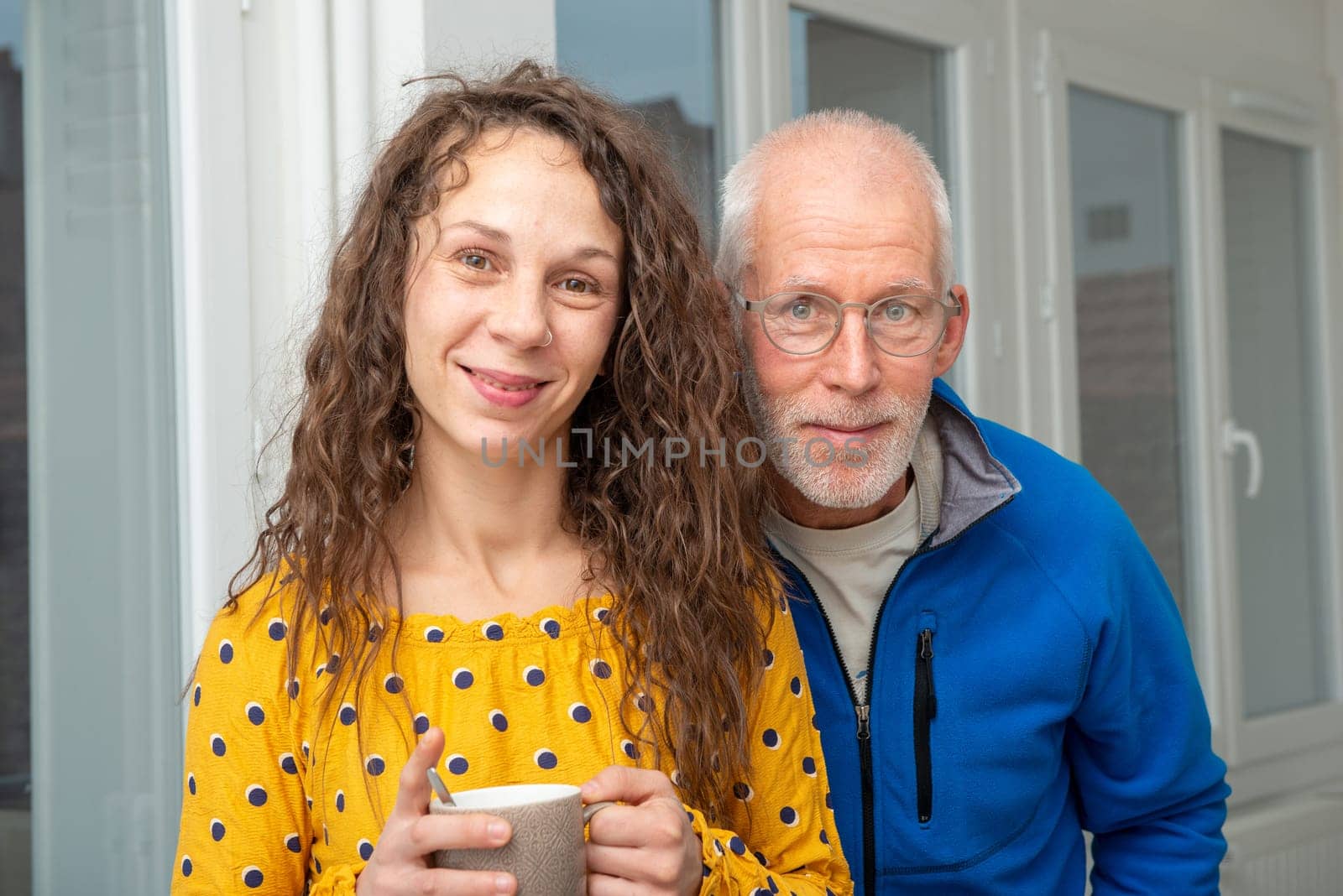 Father and daughter smiling together at home