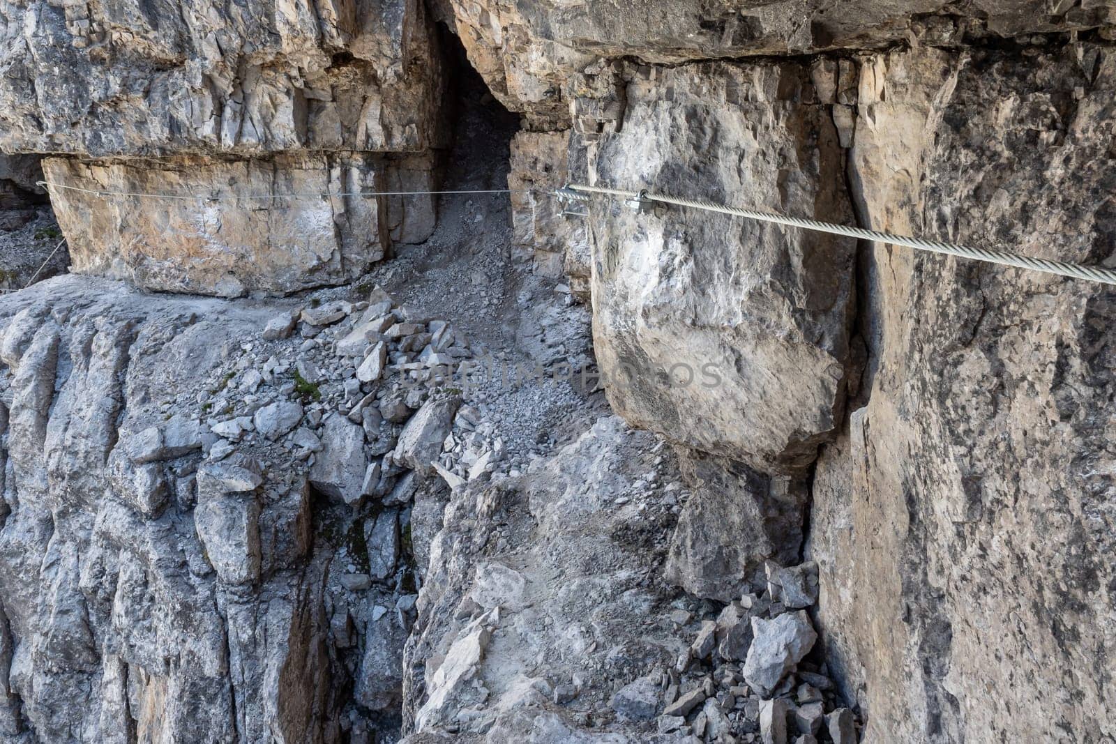 Fixed-rope Route, climbing a via ferrata route. Italian Alps. Mountain tourism in the Dolomites. Region Brenta, Italy.