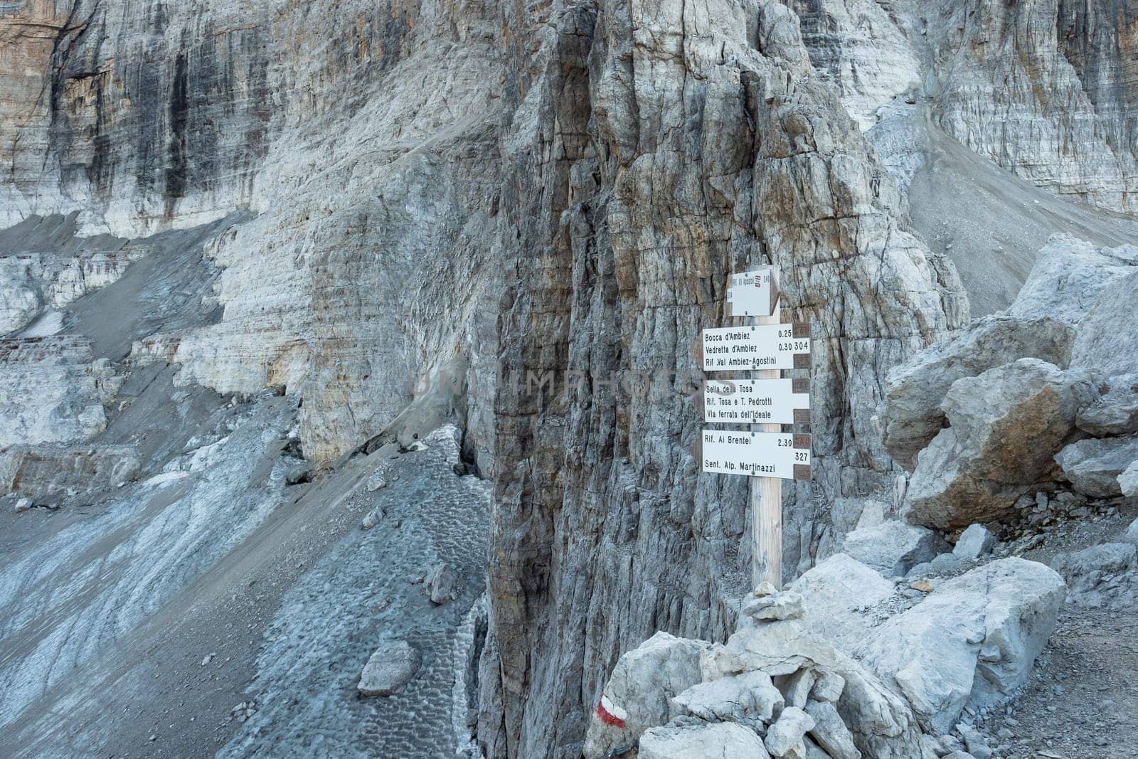 Trekking direction indicators. Tourist paths directions and travel time shown on a traditional direction signs at the Dolomiti mountains, Italy
