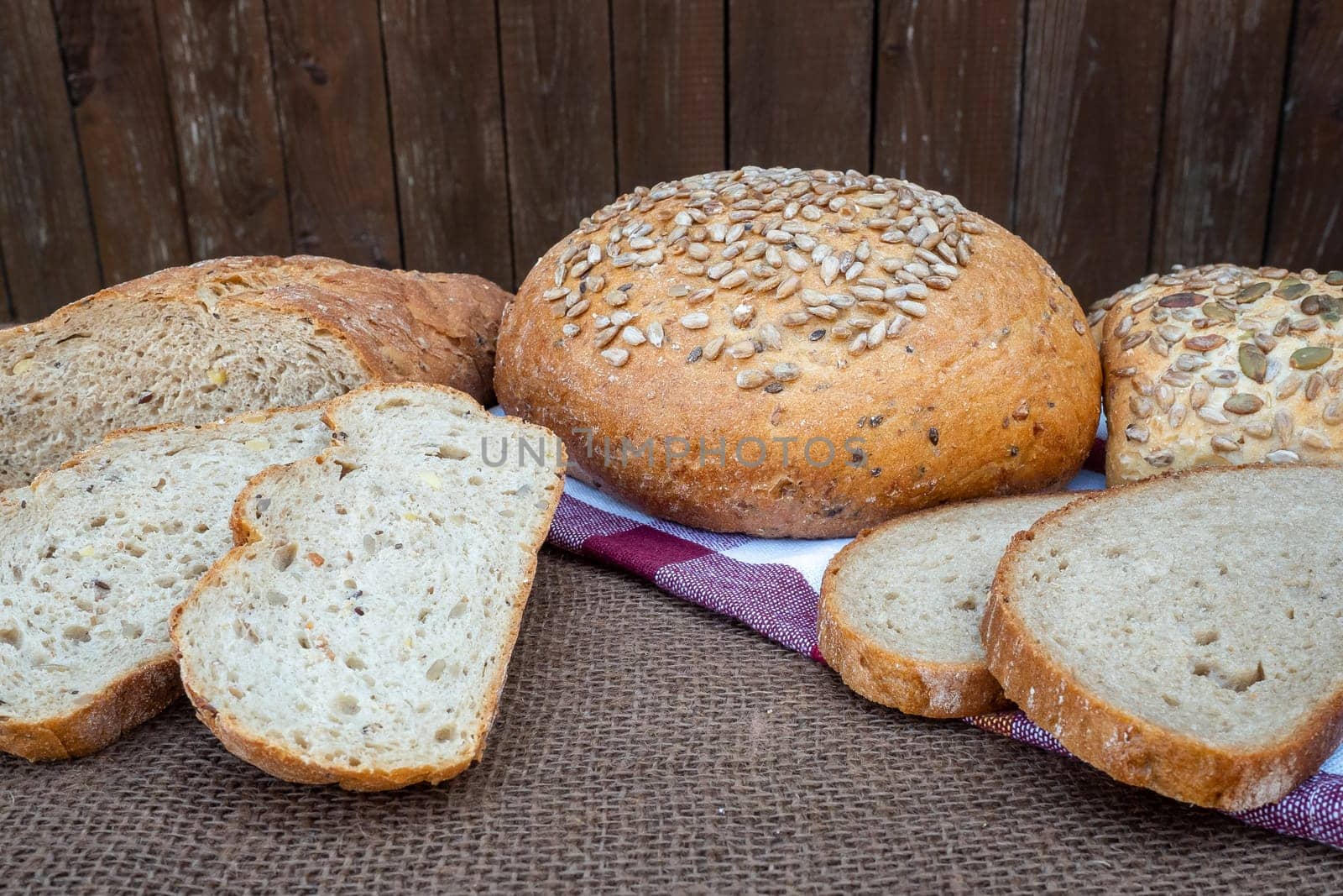 Fresh bread on table. Baked dark bread and sliced bread.