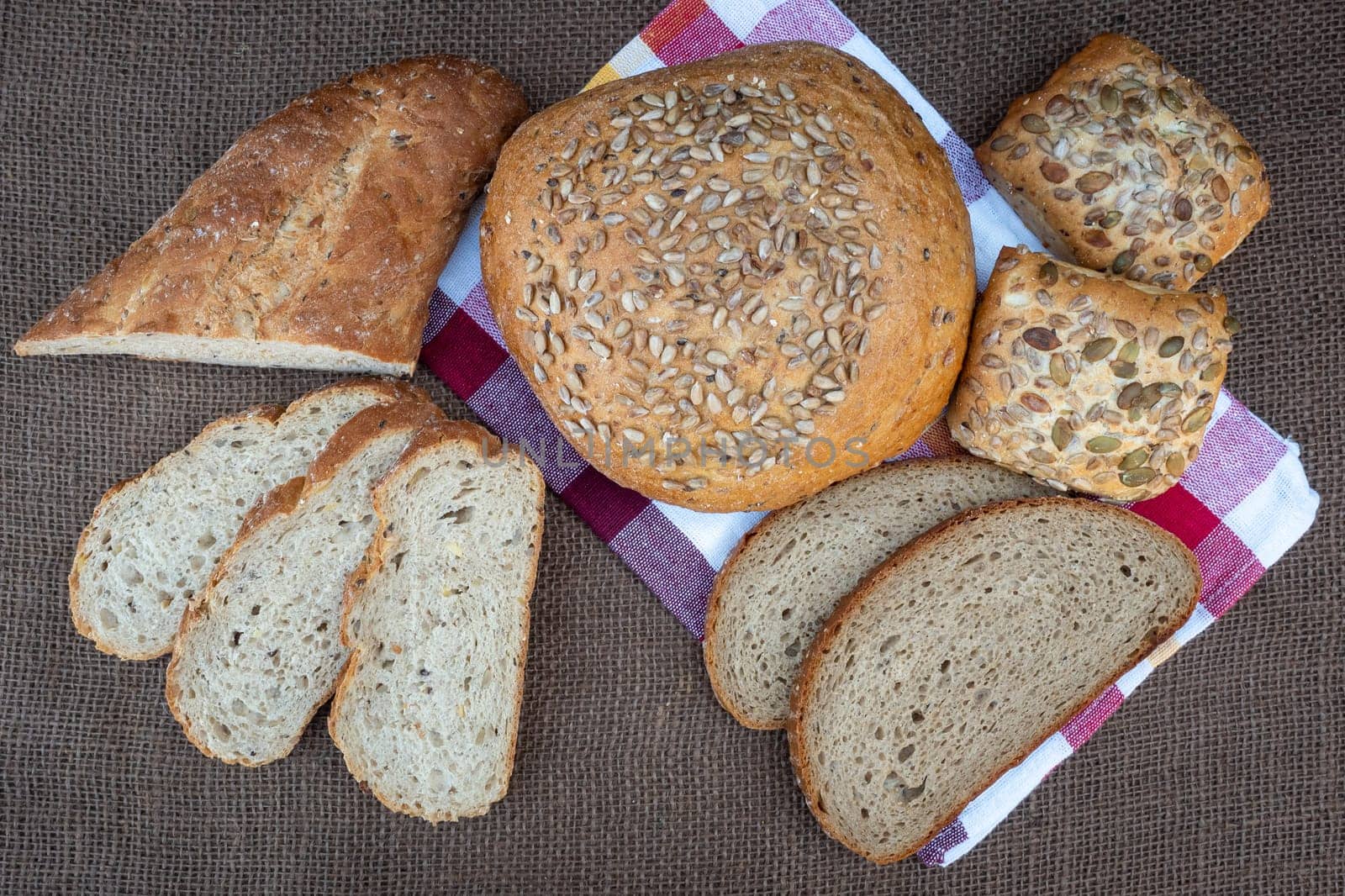 Fresh bread on table, top view. Baked dark bread and sliced bread.