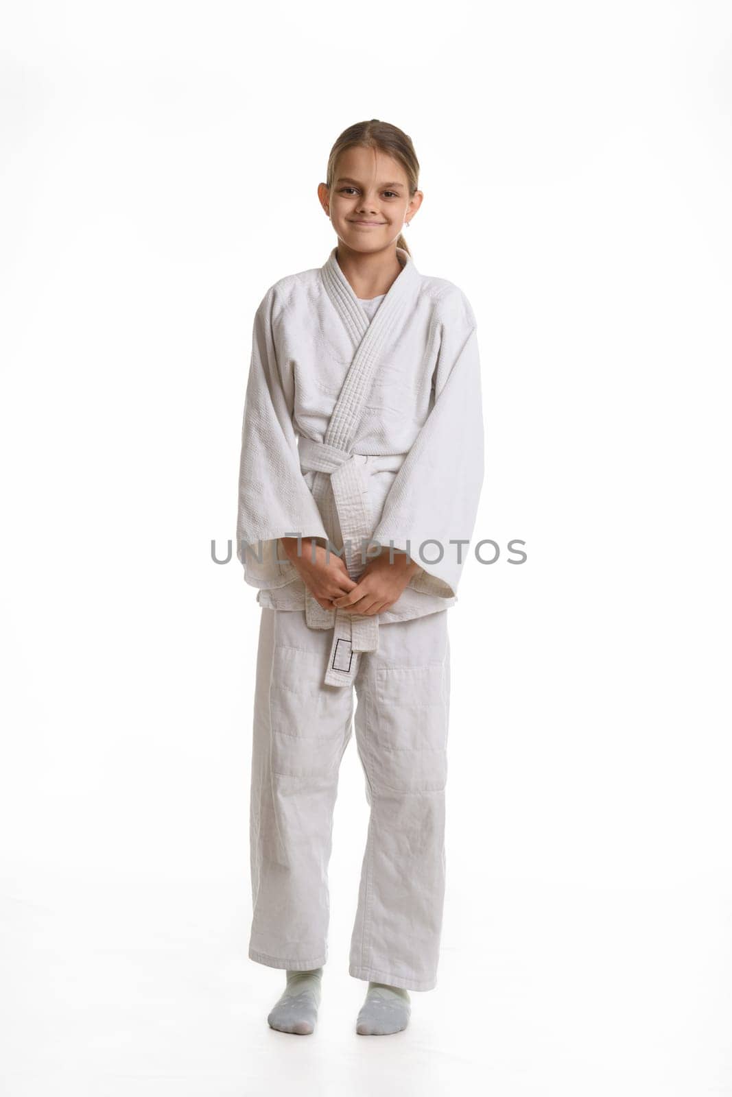 Funny and humble girl in a kimono, isolated on a white background