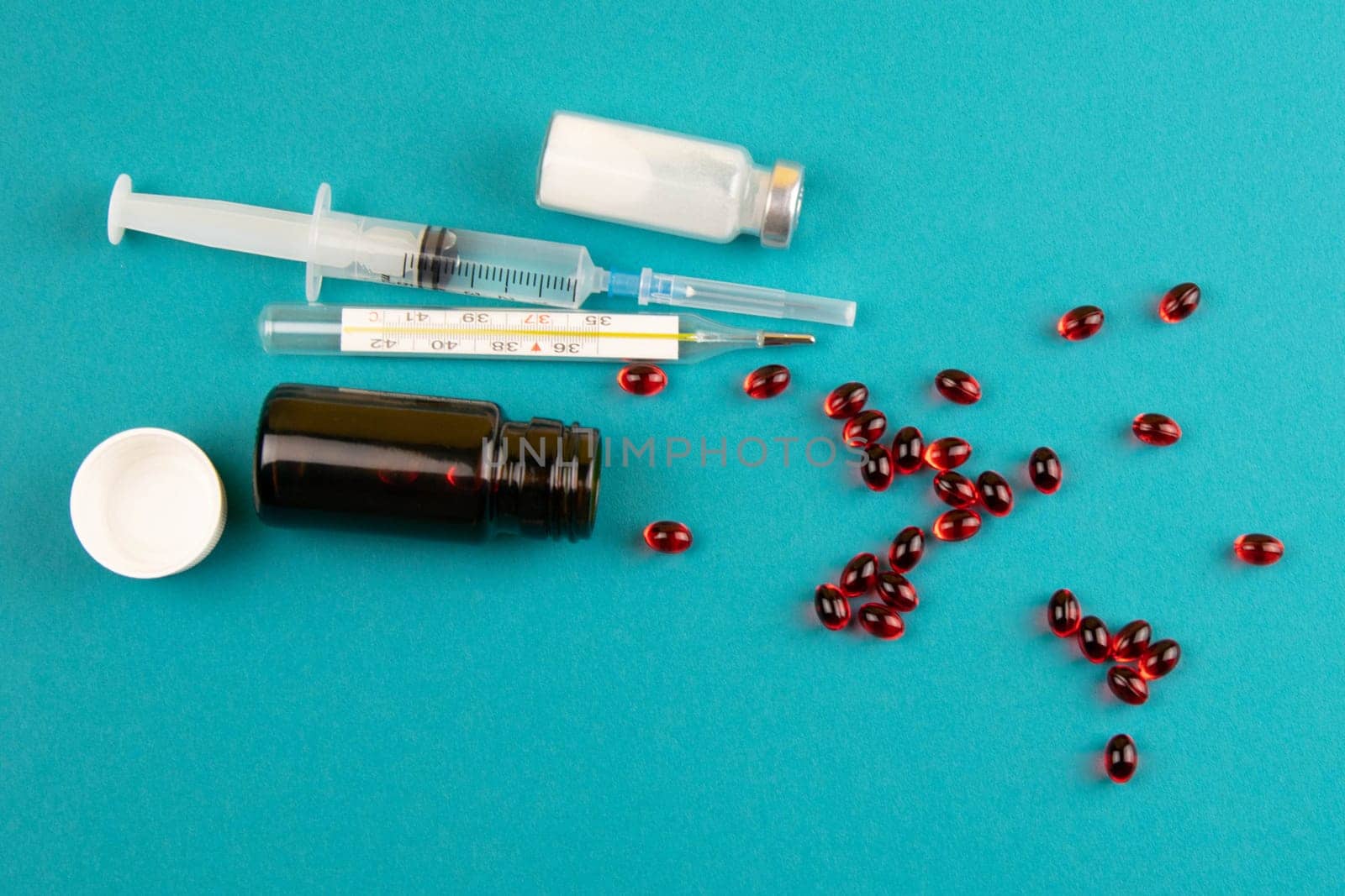 Lemon, ginger, and chapel against multi-colored tablets. The concept of choosing a healthy diet versus taking medication. Top views with clear space