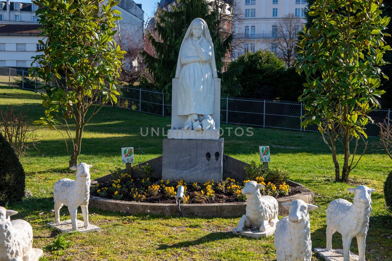 the Statue of Bernadette of Lourdes with flowers
