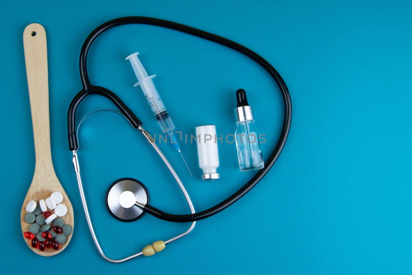 Pills of different colours lay on blue background. Colorful antibacterials pills, capsules of medicine.