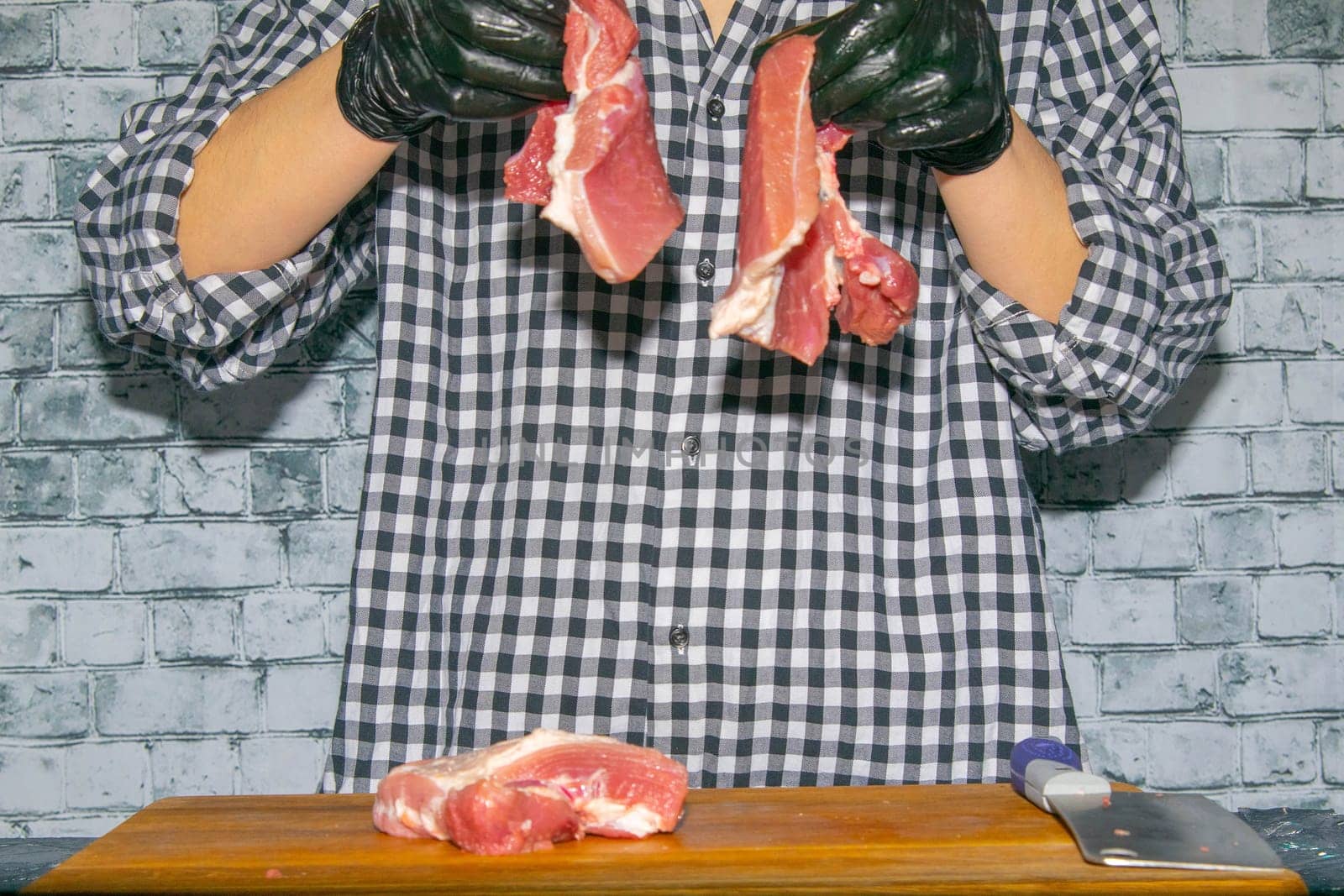 Preparing for the preparation of hamburgers. On a wooden board are lettuce leaves, chopped: tomatoes, cucumbers, onions, cutlets and sauces.