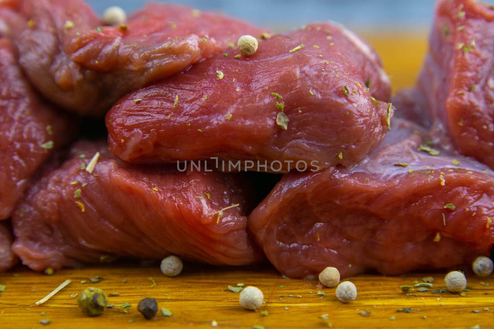 Preparing for the preparation of hamburgers. On a wooden board are lettuce leaves, chopped: tomatoes, cucumbers, onions, cutlets and sauces.