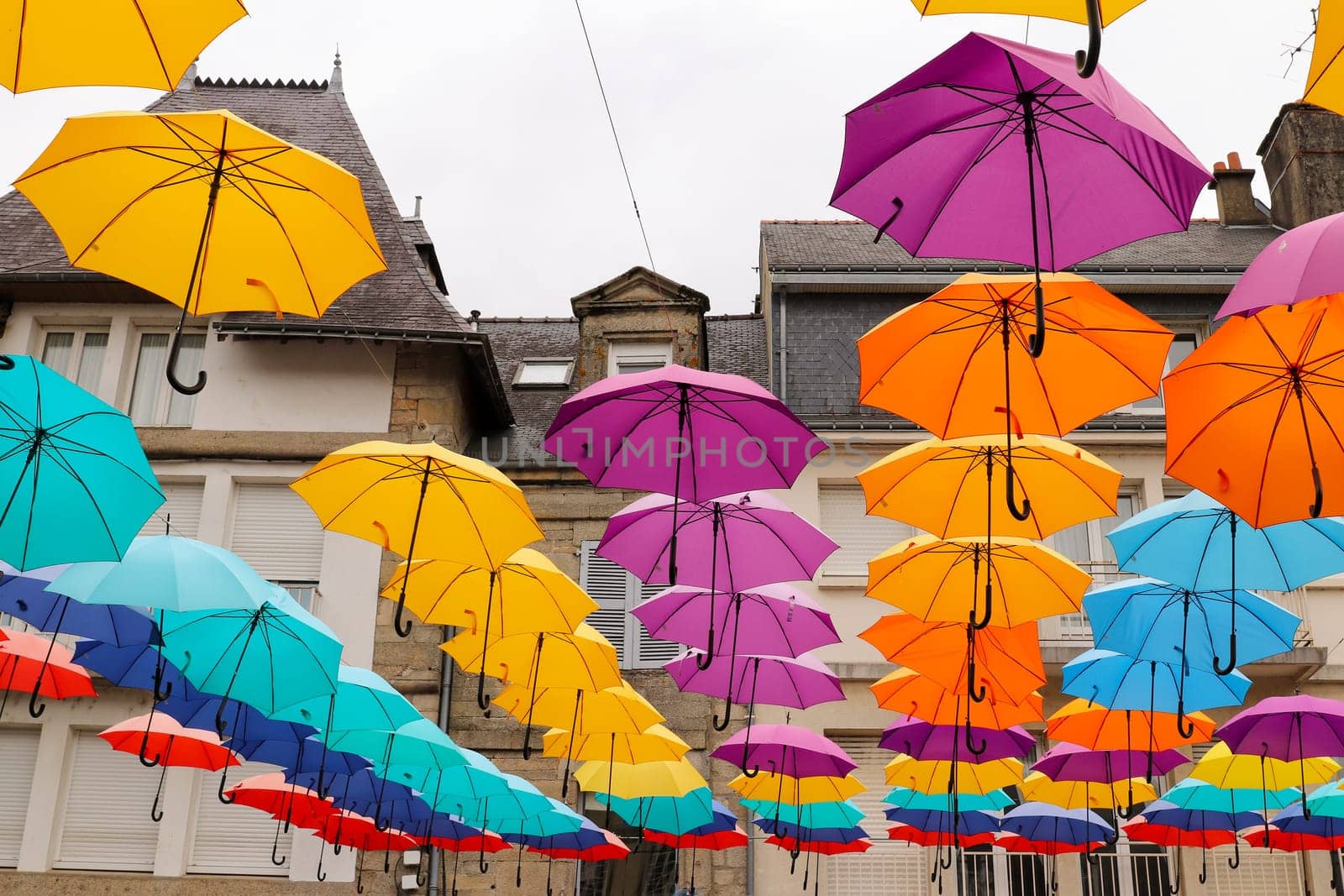 Pontivy, France, August 6, 2019: Colorful umbrellas hanging over the square du Martray. Pontivy, Morbihan, Brittany, France