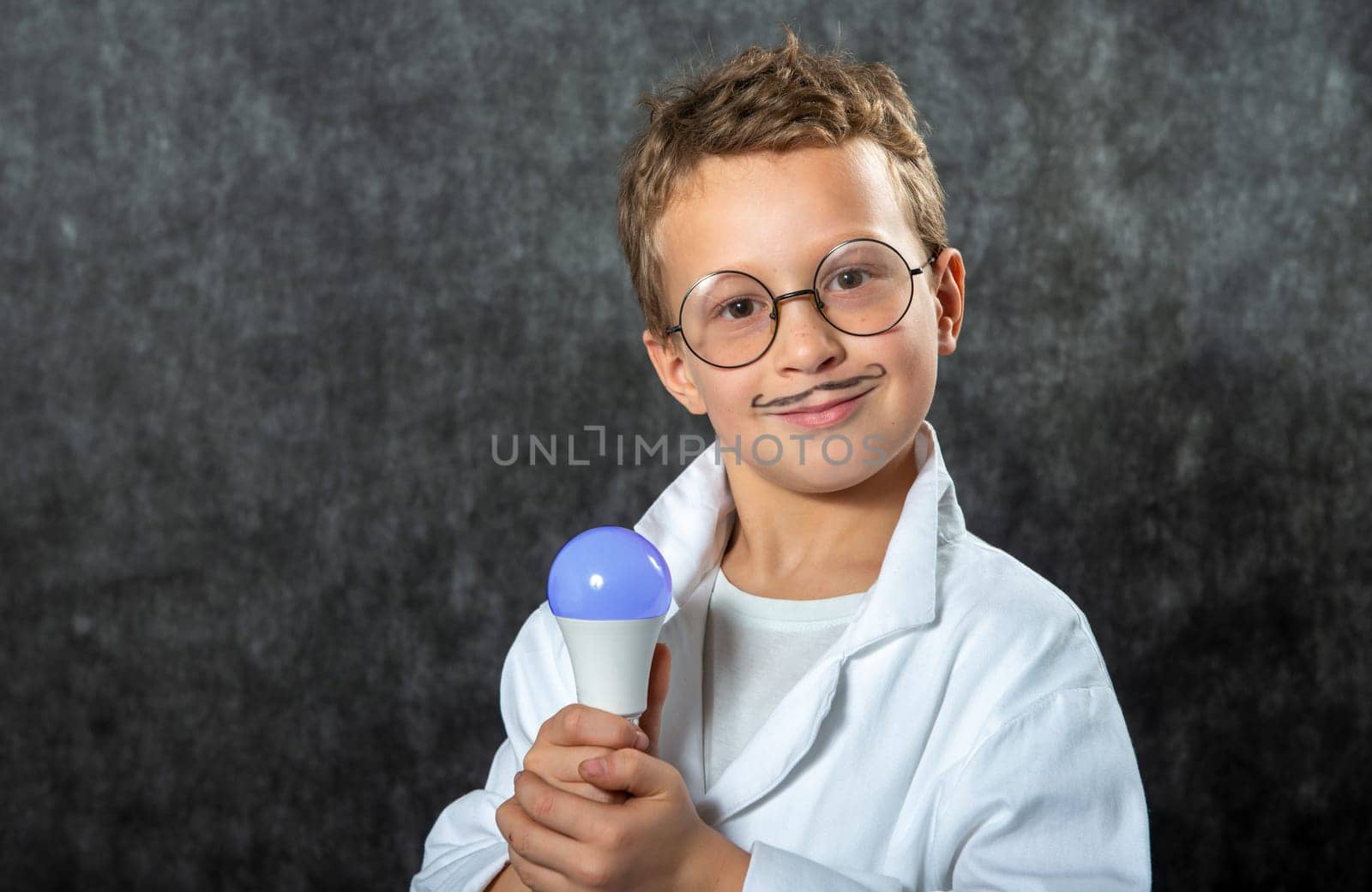 cute smiling child boy with a light bulb