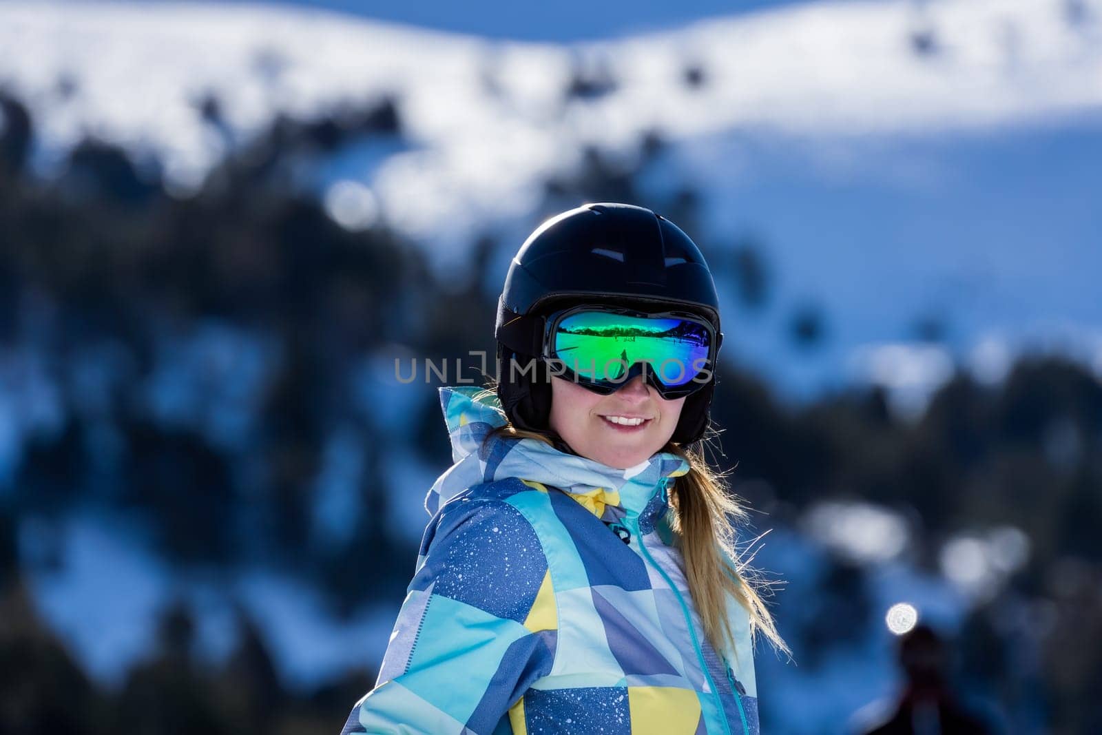 Portrait of smiling Caucasian white woman, skier with ski helmet and goggles. Winter holidays in El Tarter, Grandvalira, Andorra