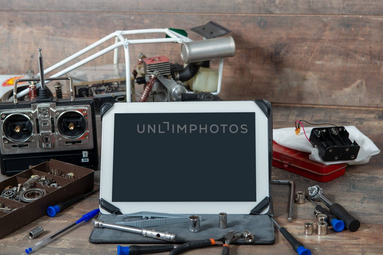 tablet with a rc radio control car and tools