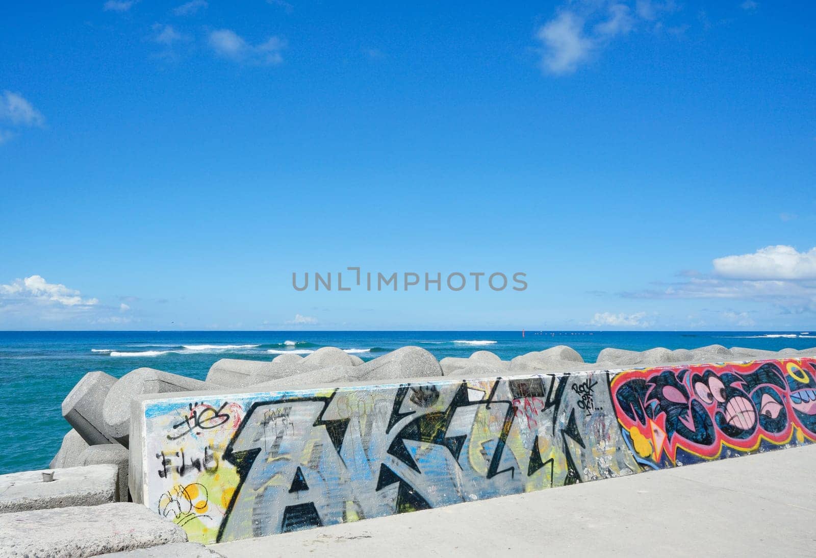Seaside rampart decorated with graffiti on the Sunset beach in Chatan City in the American Village of Okinawa island in Japan.