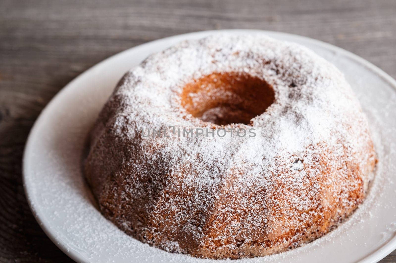 Home made freshly baked whole marble cake covered with powdered sugar