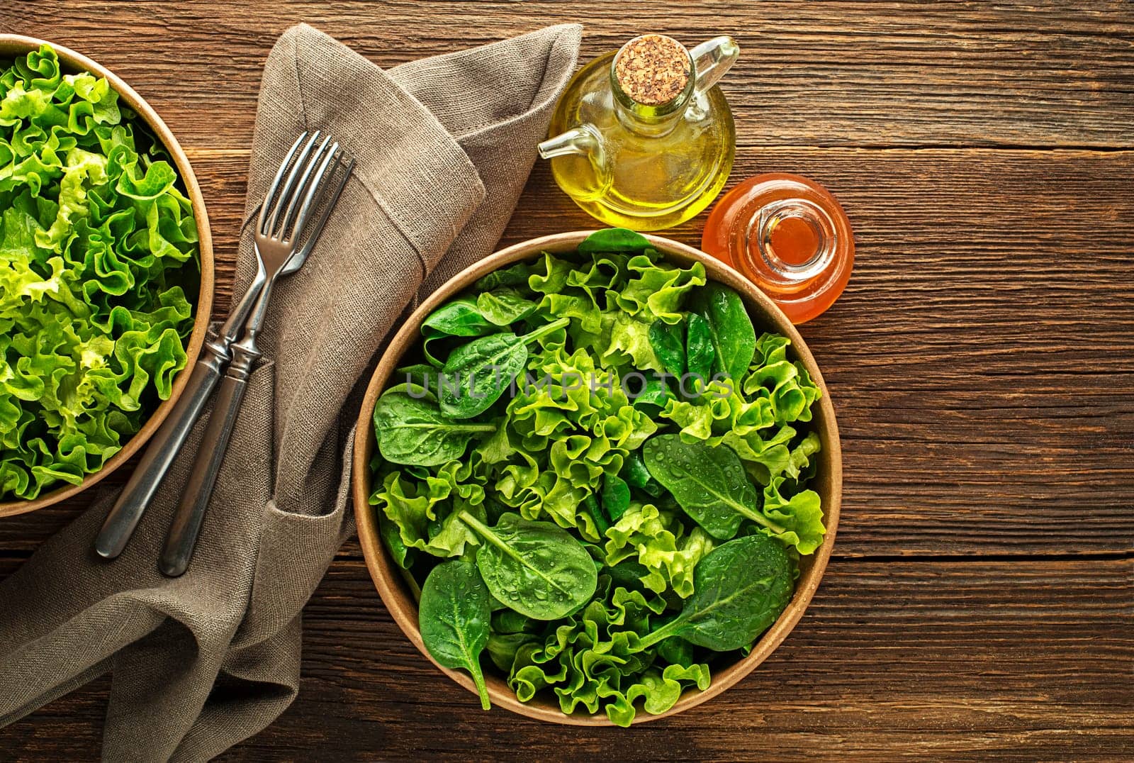 Healthy green salad on wooden table background. Healthy meal.