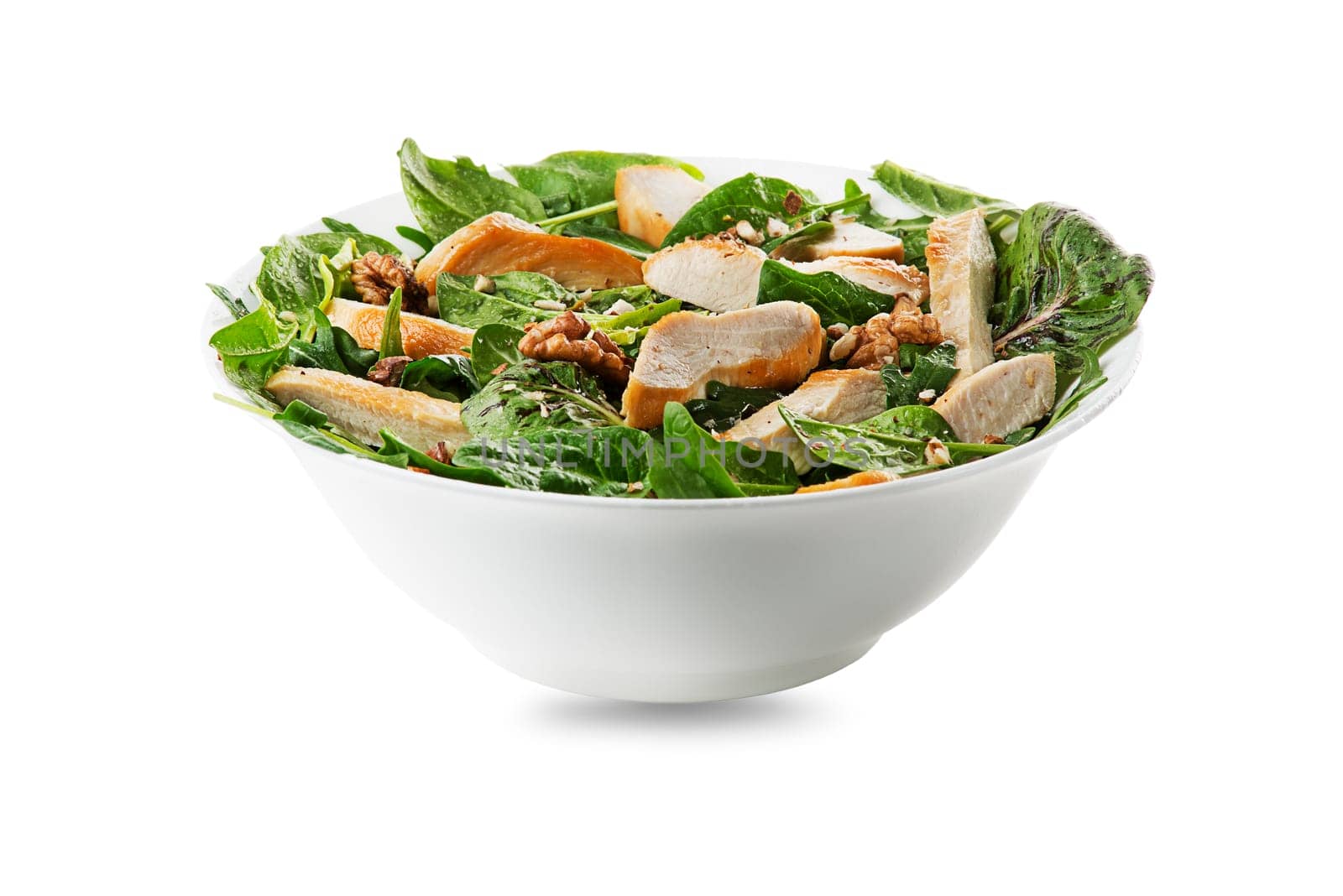 Healthy green salad with chicken breast and nuts isolated on white background