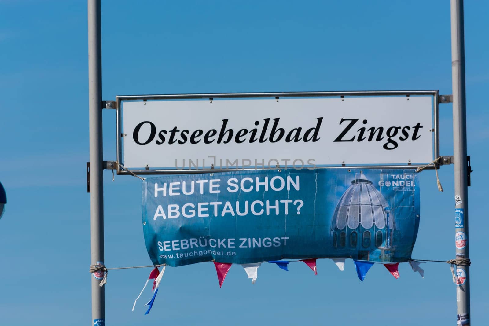 ZINGT GERMANY - JULY 29 2018: Poster and sign with Zingst inscription on the wooden pier in the Baltic Sea. Darss Peninsula Fischland-Darss-Zingst Germany.At the pier of Zingst on the Baltic Sea in Germany