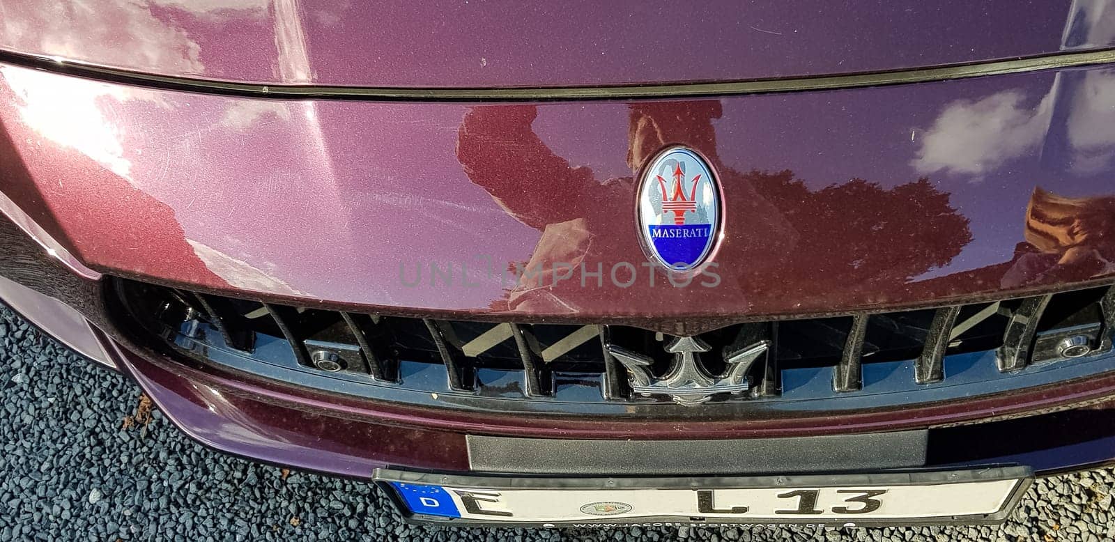 VELBERT, NRW, GERMANY - SEPTEMBER 07, 2018: bonnet with emblem and trademark of a Maserati in the car color claret.