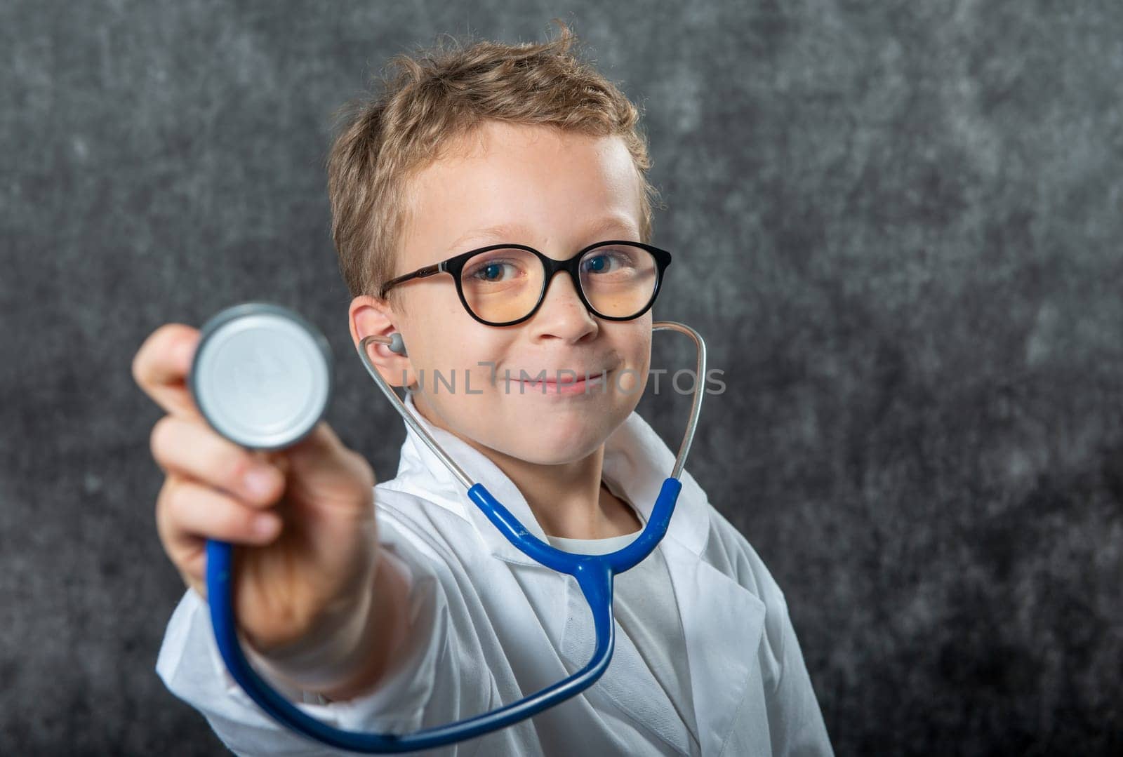 Cute kid boy wear medical uniform playing doctor, a portrait
