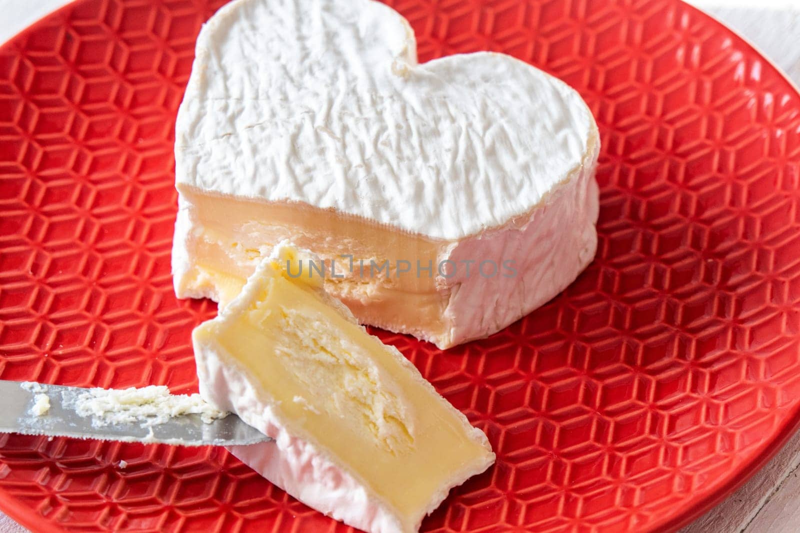 French Neufchatel cheese shaped heart in the red plate