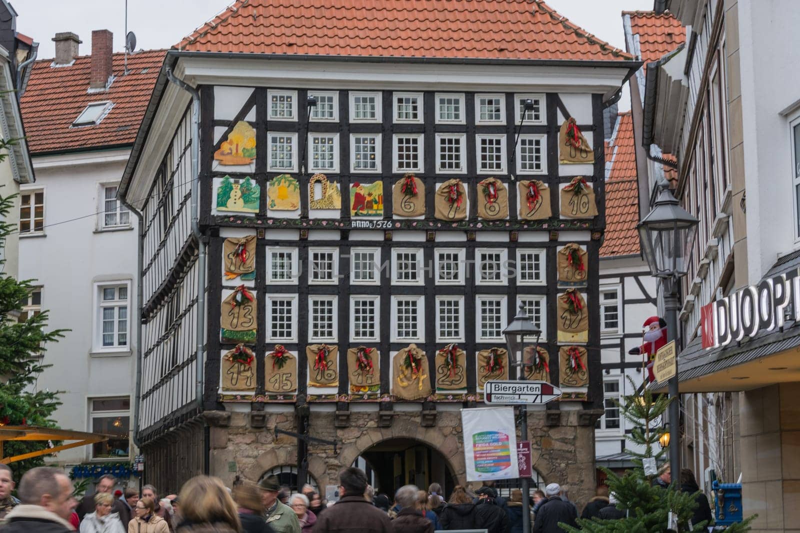 HATINGEN, NRW, GERMANY - DECEMBER 6, 2015:.People at the Christmas market in Hattingen in the background an old half-timbered house with giant Advent calendar.