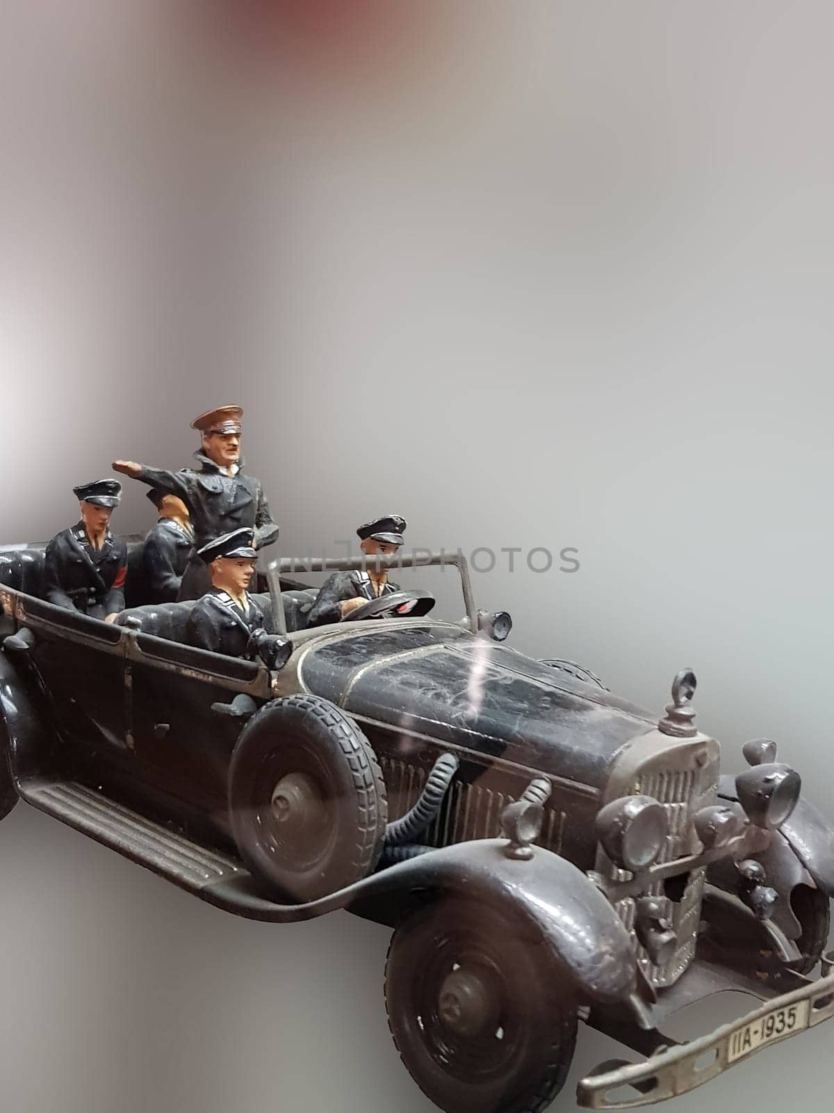 Selective focus views of a model car made of sheet metal with tin soldiers on an exhibition..