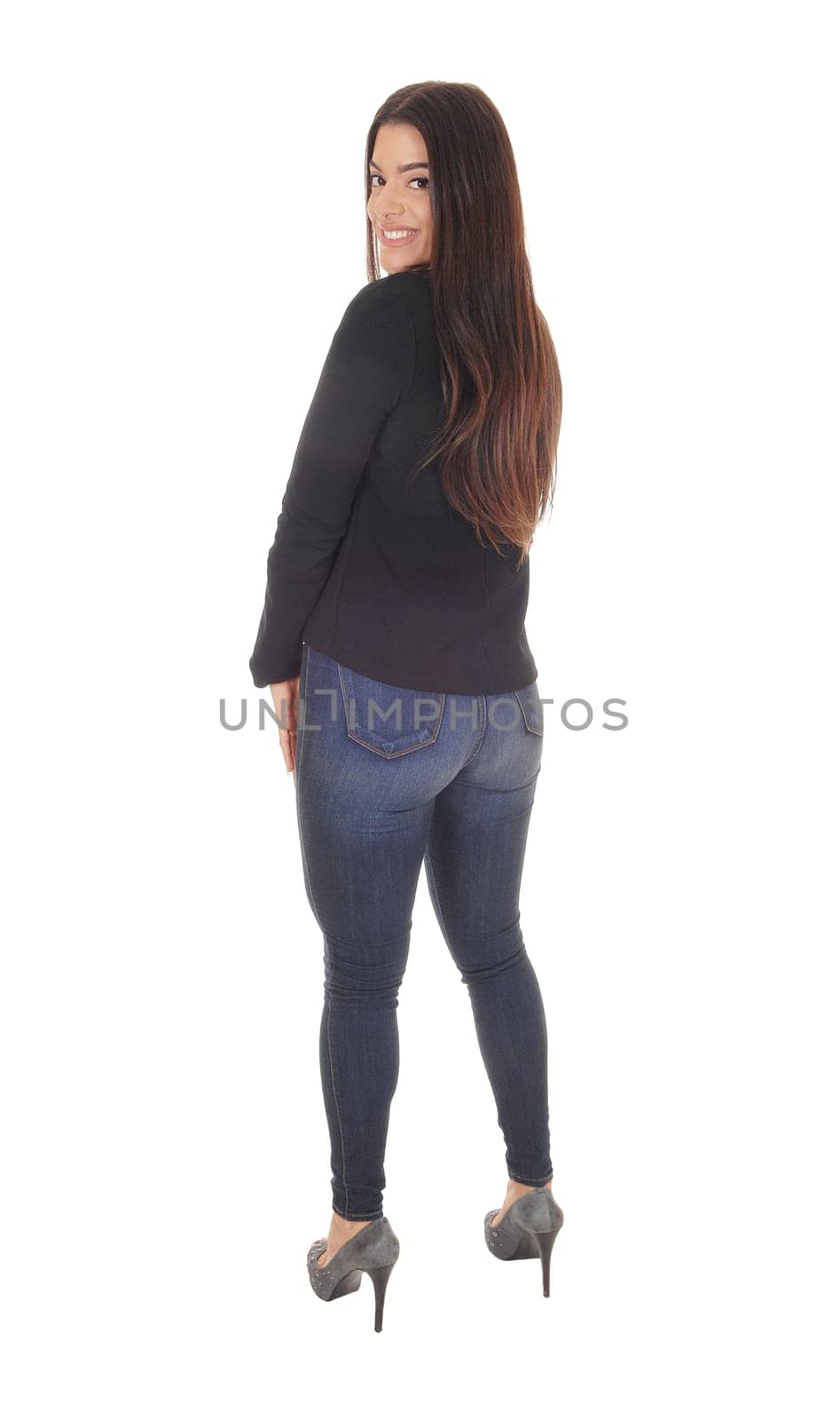 A gorgeous young woman standing in jeans and a black jacket.as business outfit from the back, isolated for white background.