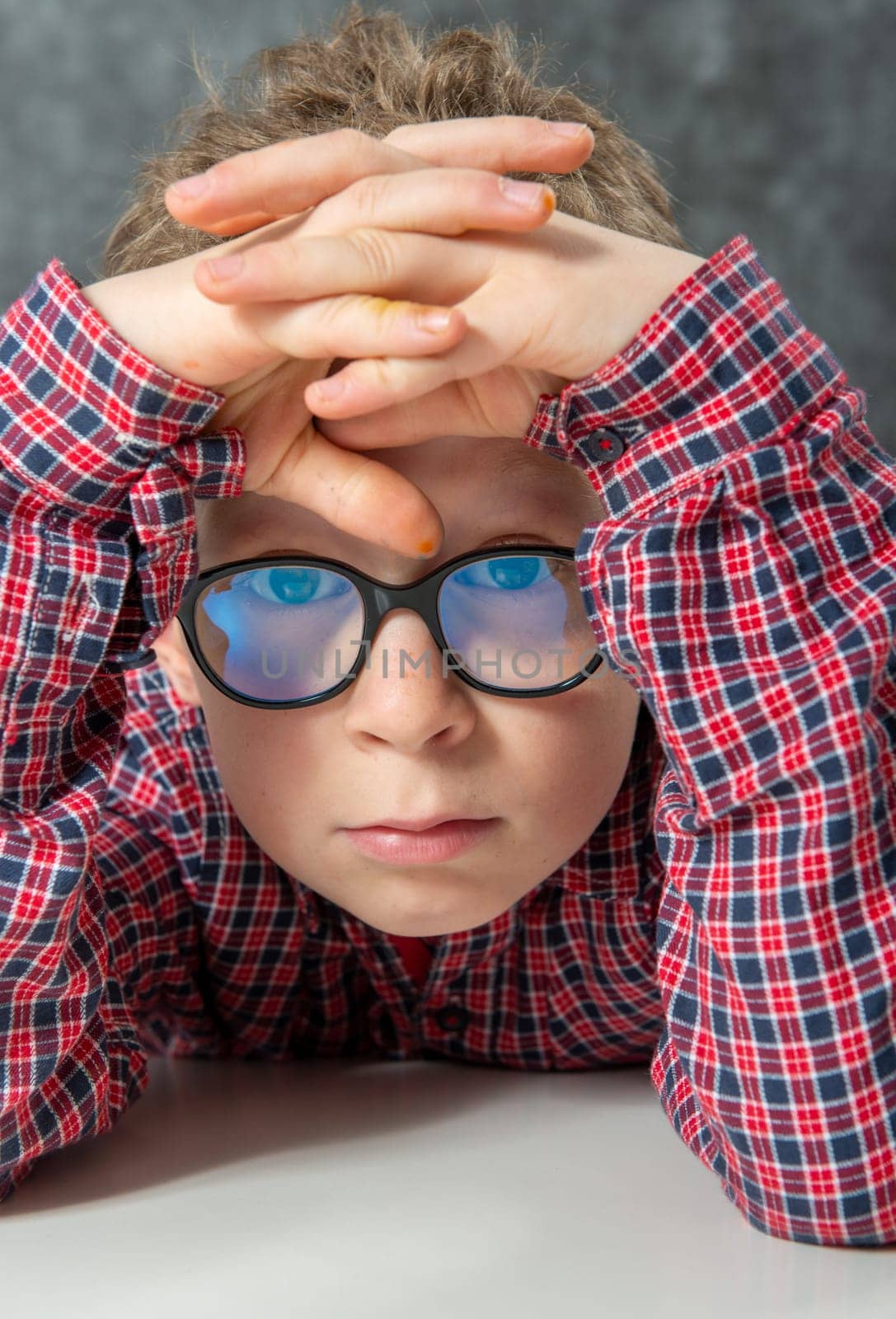 portrait of pensive cute child with a checkered shirt