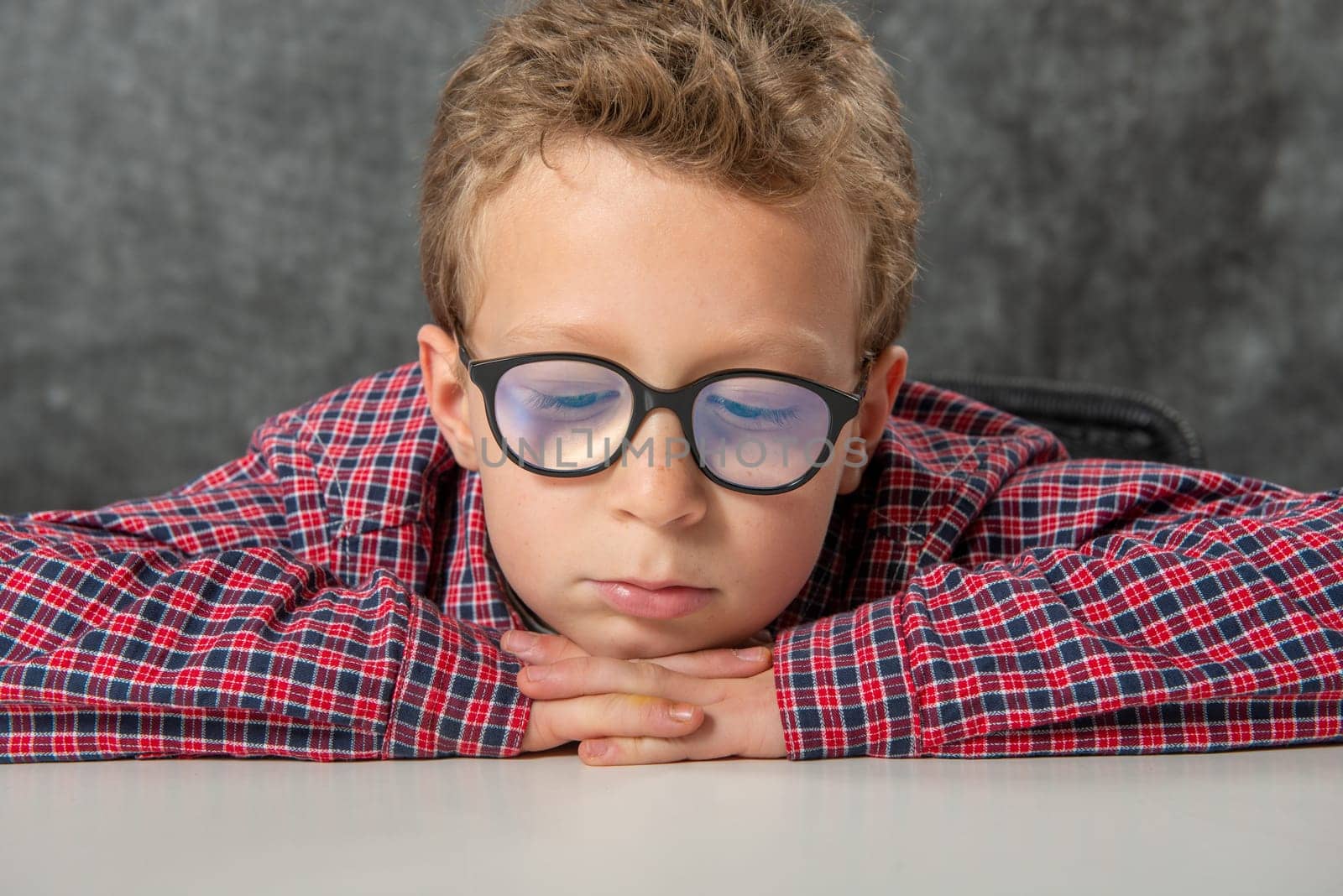 portrait of pensive cute child with a checkered shirt