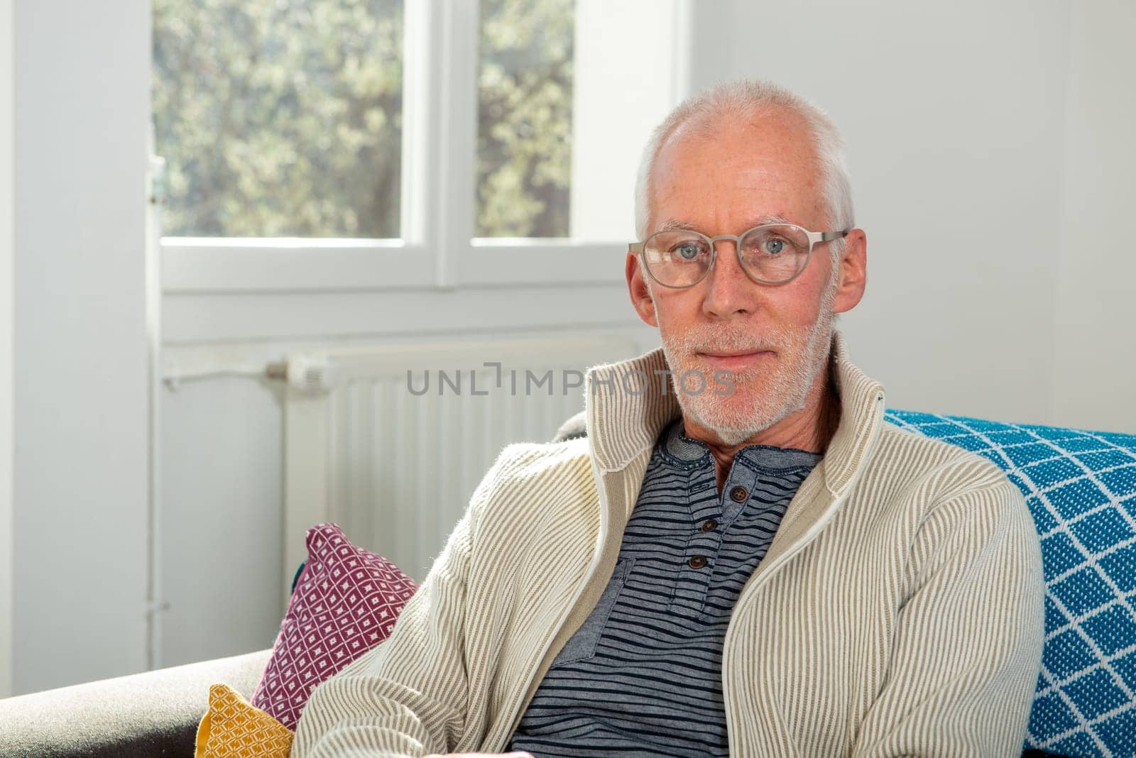 portrait of senior with white hairs wearing eyeglasses