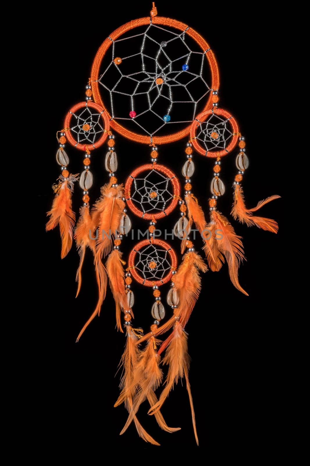 Pearl-embroidered dream catcher with colorful feathers and pearls against a black background