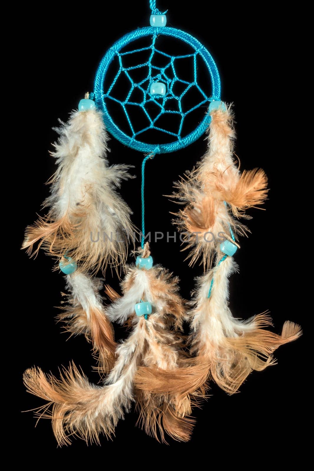 Pearl-embroidered dream catcher with colorful feathers and pearls against a black background