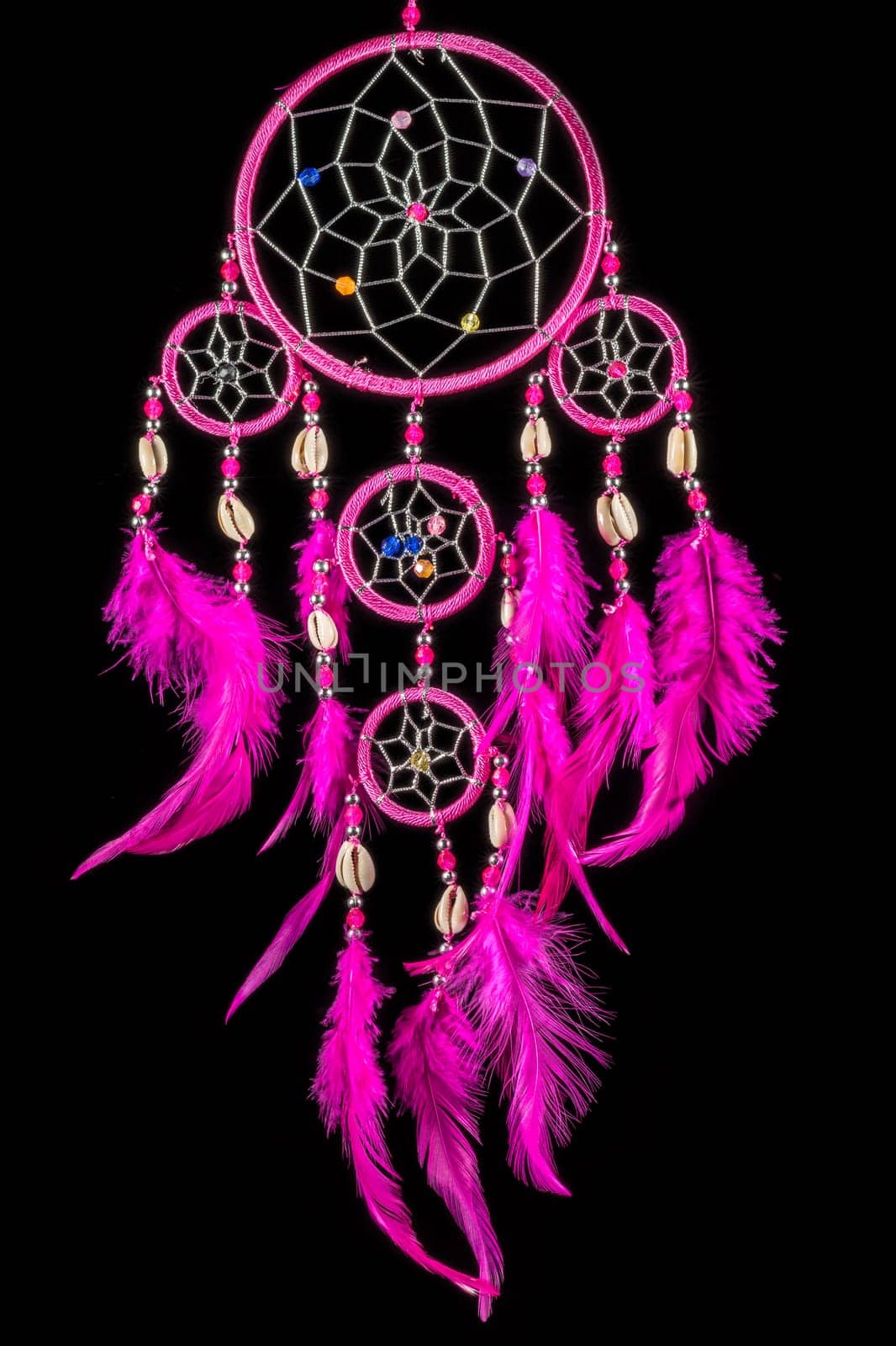 Pearl-embroidered dream catcher with colorful feathers and pearls against a black background