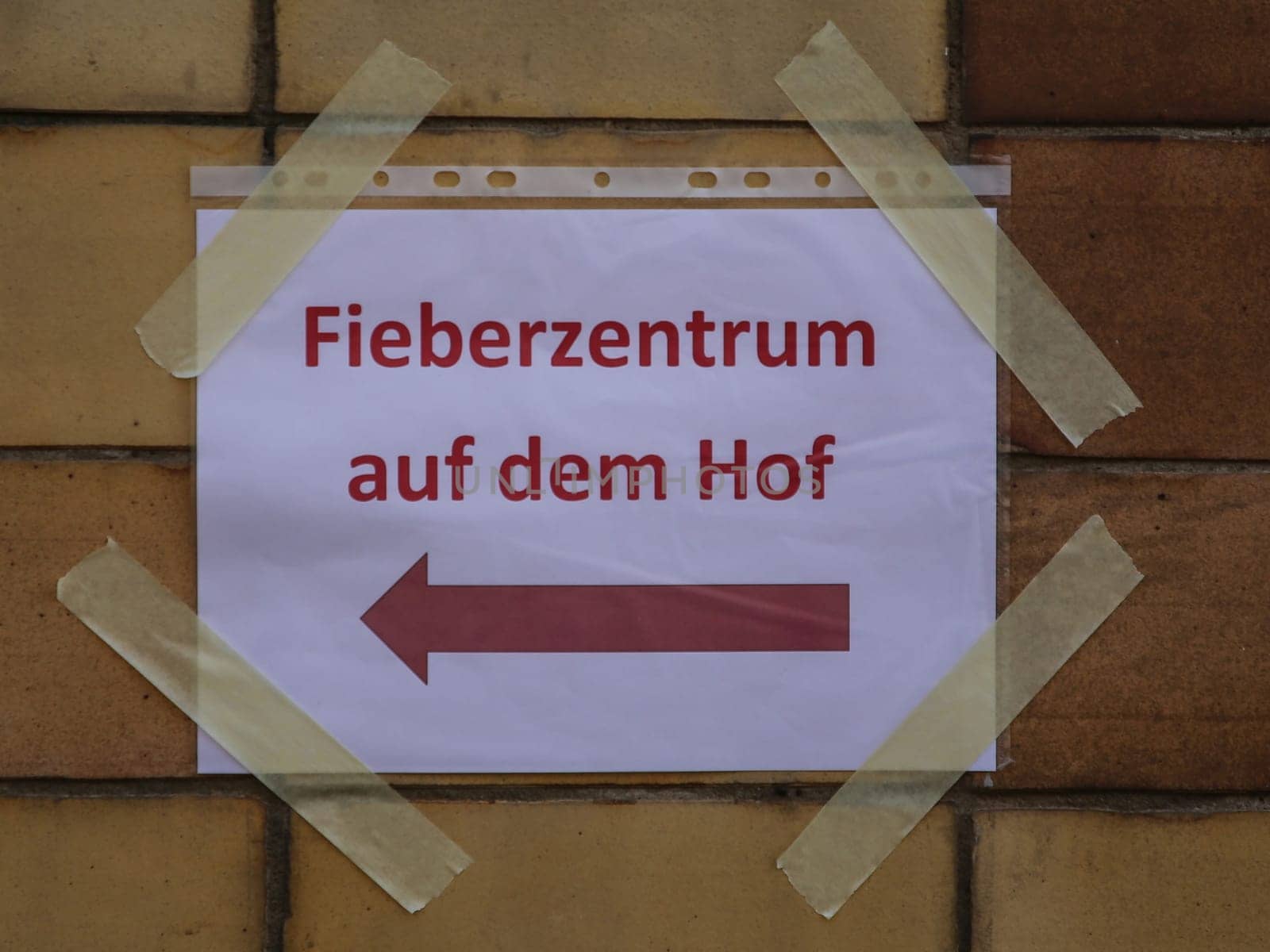 Signpost to the fever center in the courtyard during the corona virus pandemic